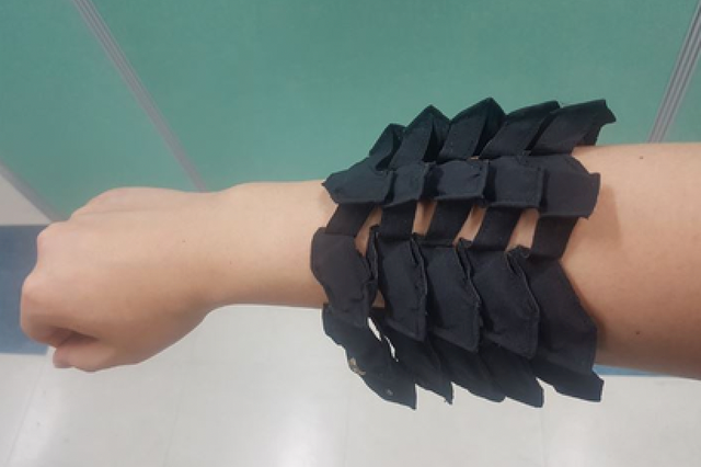 <p>Flexible, stretchable battery developed by research team at KIMM shown on an individual’s arm and hand</p>