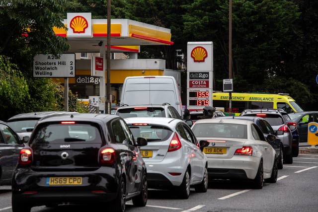 An Ambulance exits a Shell garage, which doesn't have any unleaded petrol
