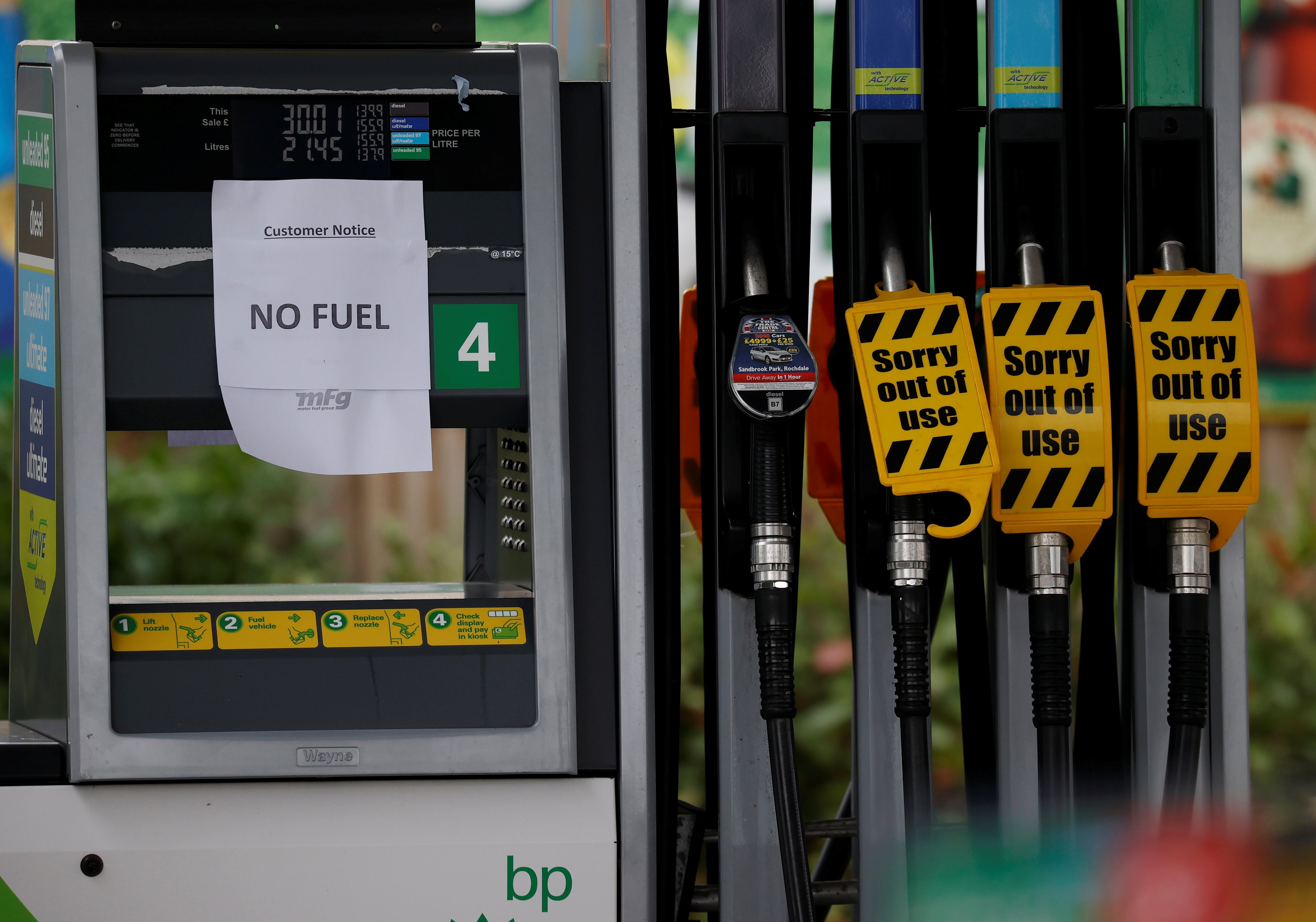 A 'No Fuel' sign attached to an empty petrol pump at a BP filling station in Manchester