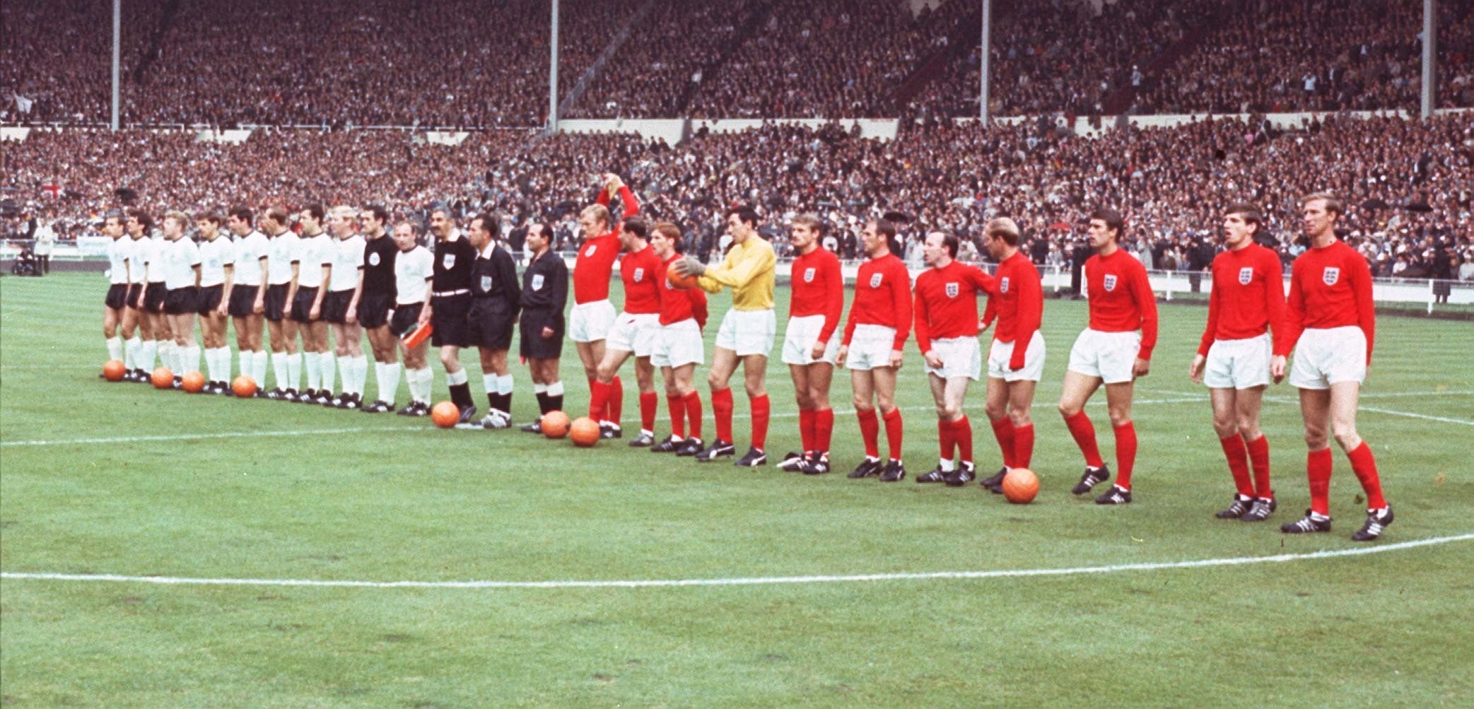 The England and West Germany teams line up on the pitch at Wembley before the 1966 World Cup final (PA)