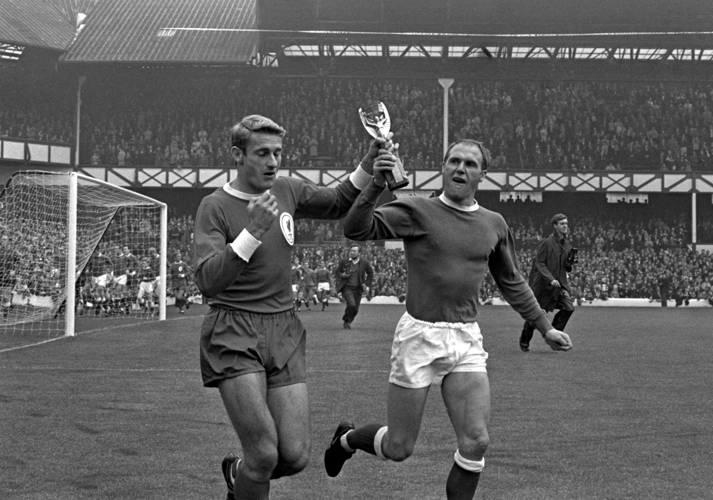 Liverpool’s Hunt, left, and Everton’s Ray Wilson parade the World Cup around Goodison Park (PA Archive).