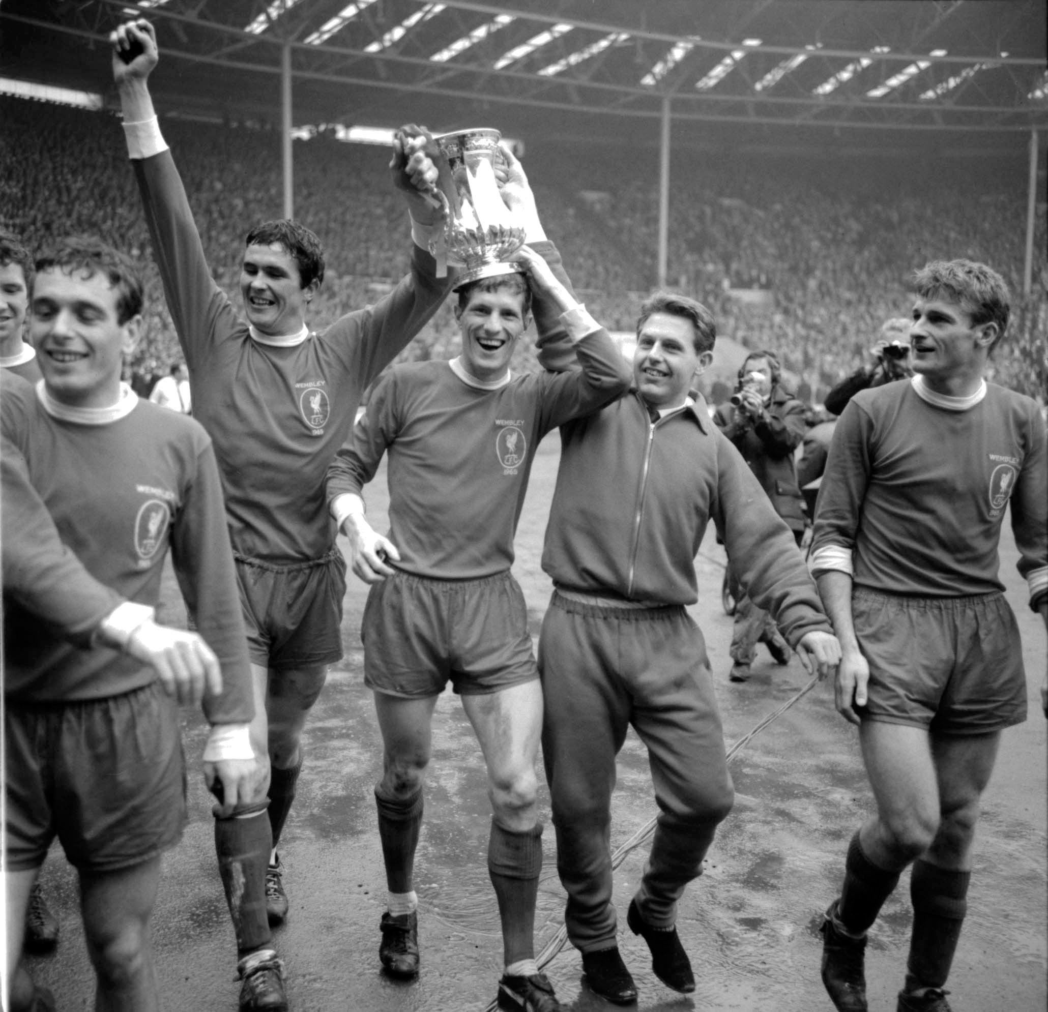 Liverpool’s Ian Callaghan, Ron Yeats, Wilf Stevenson, Gordon Milne and Roger Hunt parade the FA Cup around Wembley after their 2-1 win in 1965 (PA Archive)