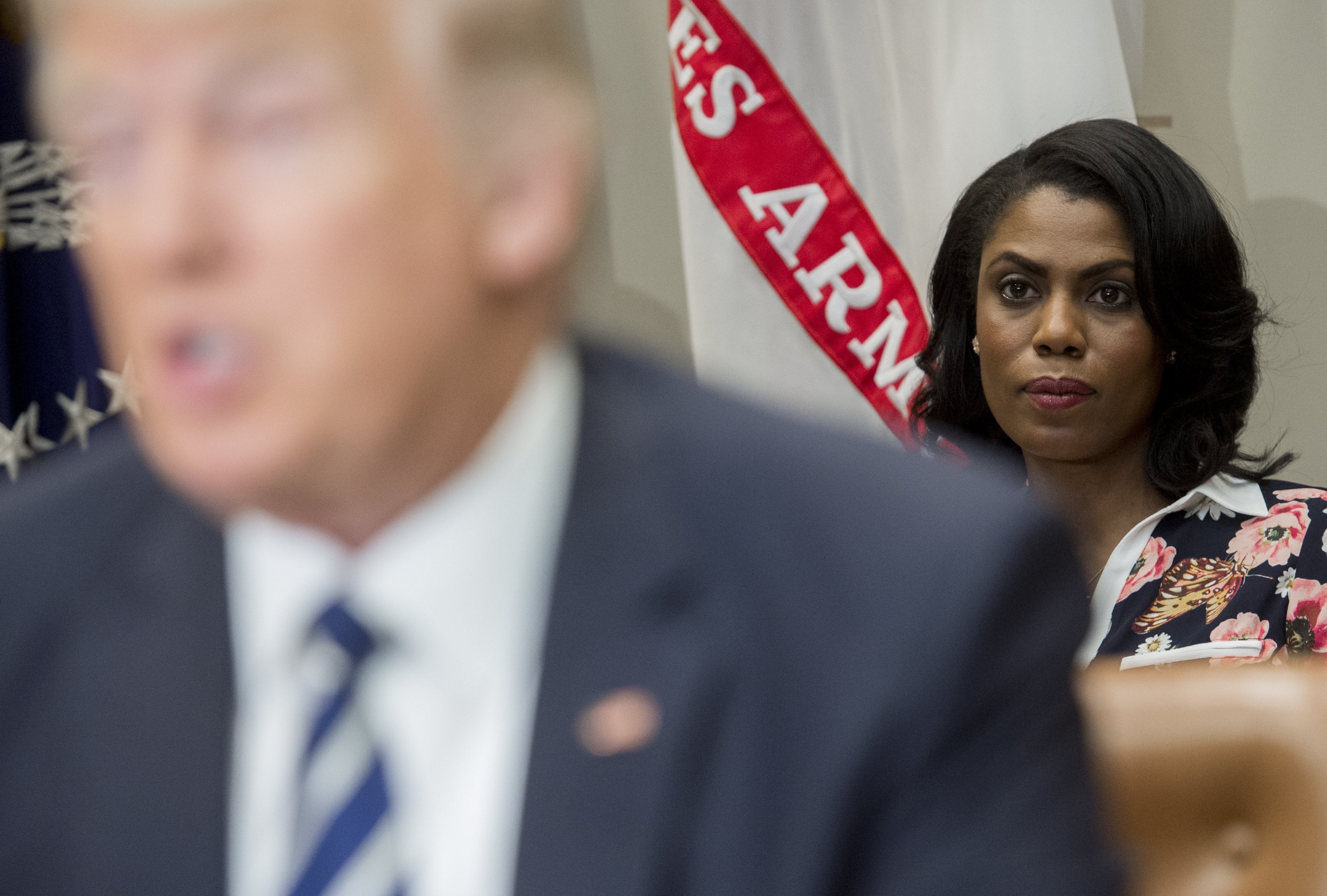 <p>Omarosa Manigault (R), White House Director of Communications for the Office of Public Liaison, sits behind US President Donald Trump as he speaks during a meeting with teachers, school administrators and parents in the Roosevelt Room of the White House in Washington, DC, February 14, 2017</p>