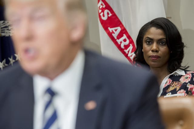 <p>Omarosa Manigault (R), White House Director of Communications for the Office of Public Liaison, sits behind US President Donald Trump as he speaks during a meeting with teachers, school administrators and parents in the Roosevelt Room of the White House in Washington, DC, February 14, 2017</p>