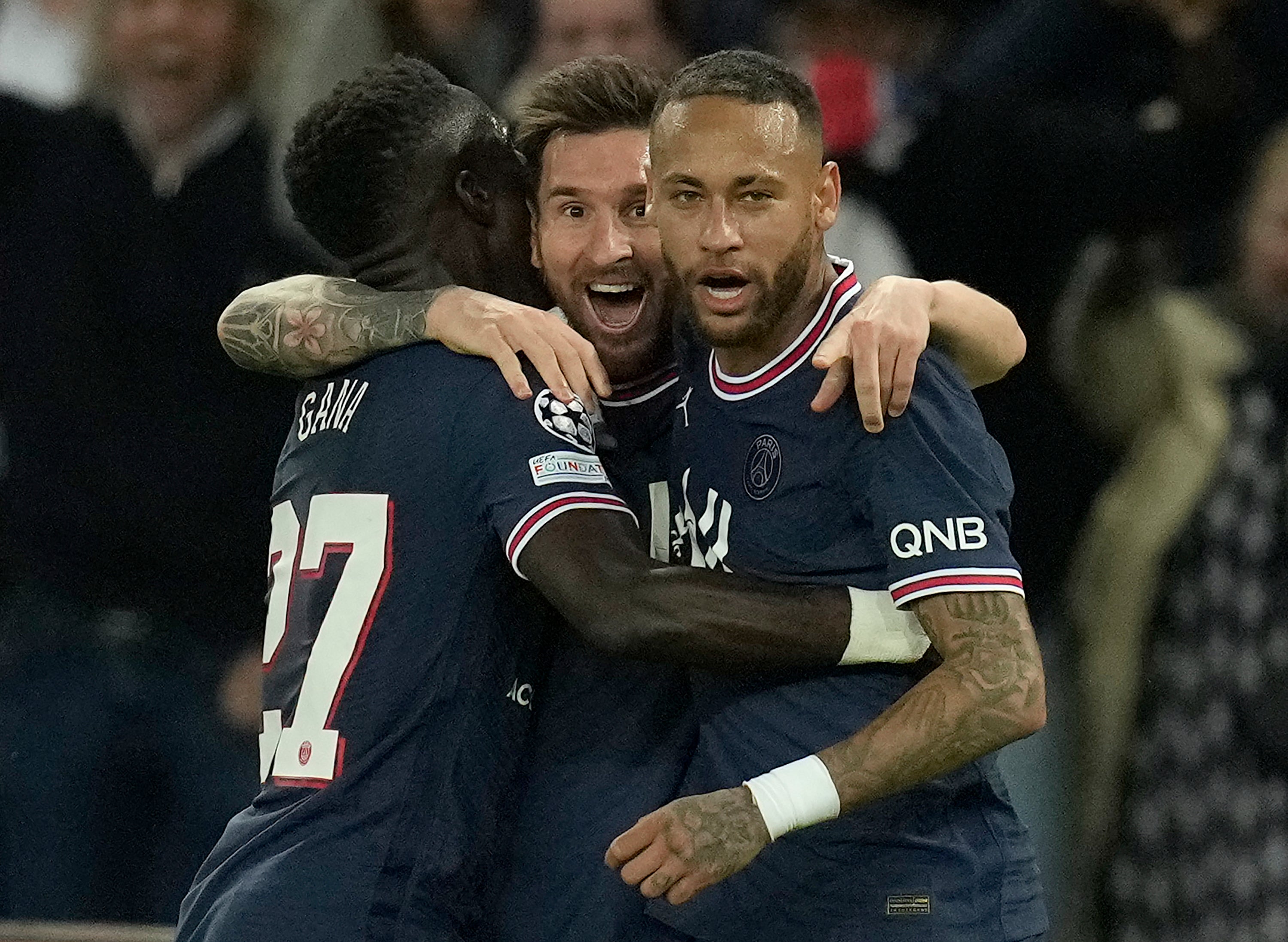 Lionel Messi, centre, celebrates his goal with fellow scorer Idrissa Gana Gueye, left, and Neymar (Christophe Ena/AP)