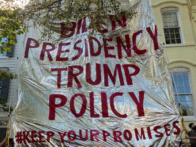 <p>Protesters from Never Again Action hold up a gigantic foil emergency blanket outside the home of Homeland Security secretary Alejandro Mayorkas</p>