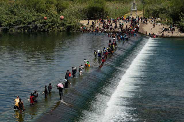 <p>Migrants attempting to cross the Texas border </p>