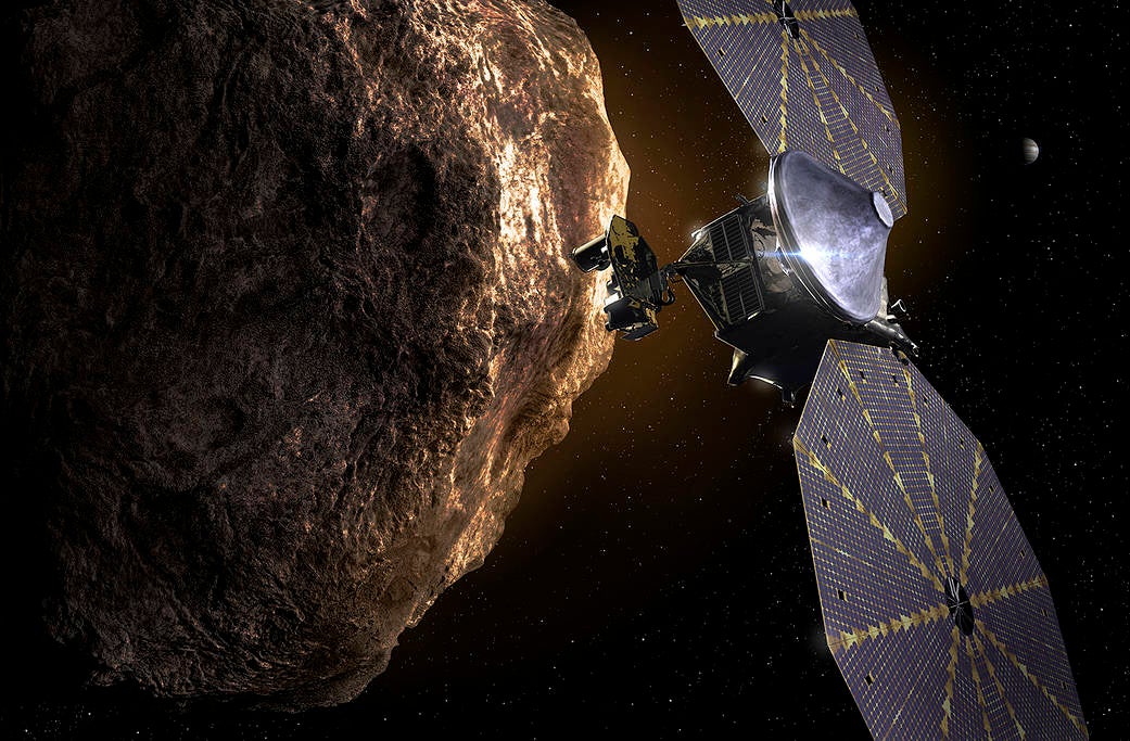 Illustration shows Lucy spacecraft passing one of the Trojan Asteroids near Jupiter