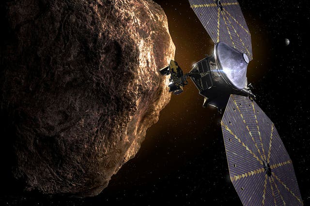 <p>Illustration shows Lucy spacecraft passing one of the Trojan Asteroids near Jupiter</p>