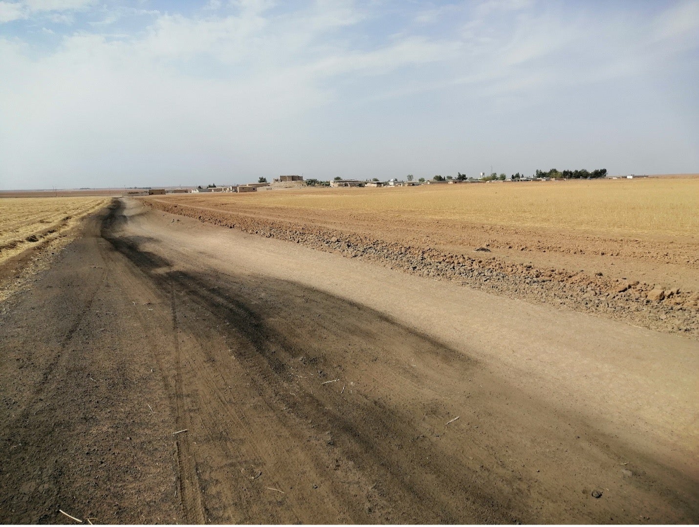 Bassam’s land has been left fallow for years, its soil layers covered with oil refinery waste