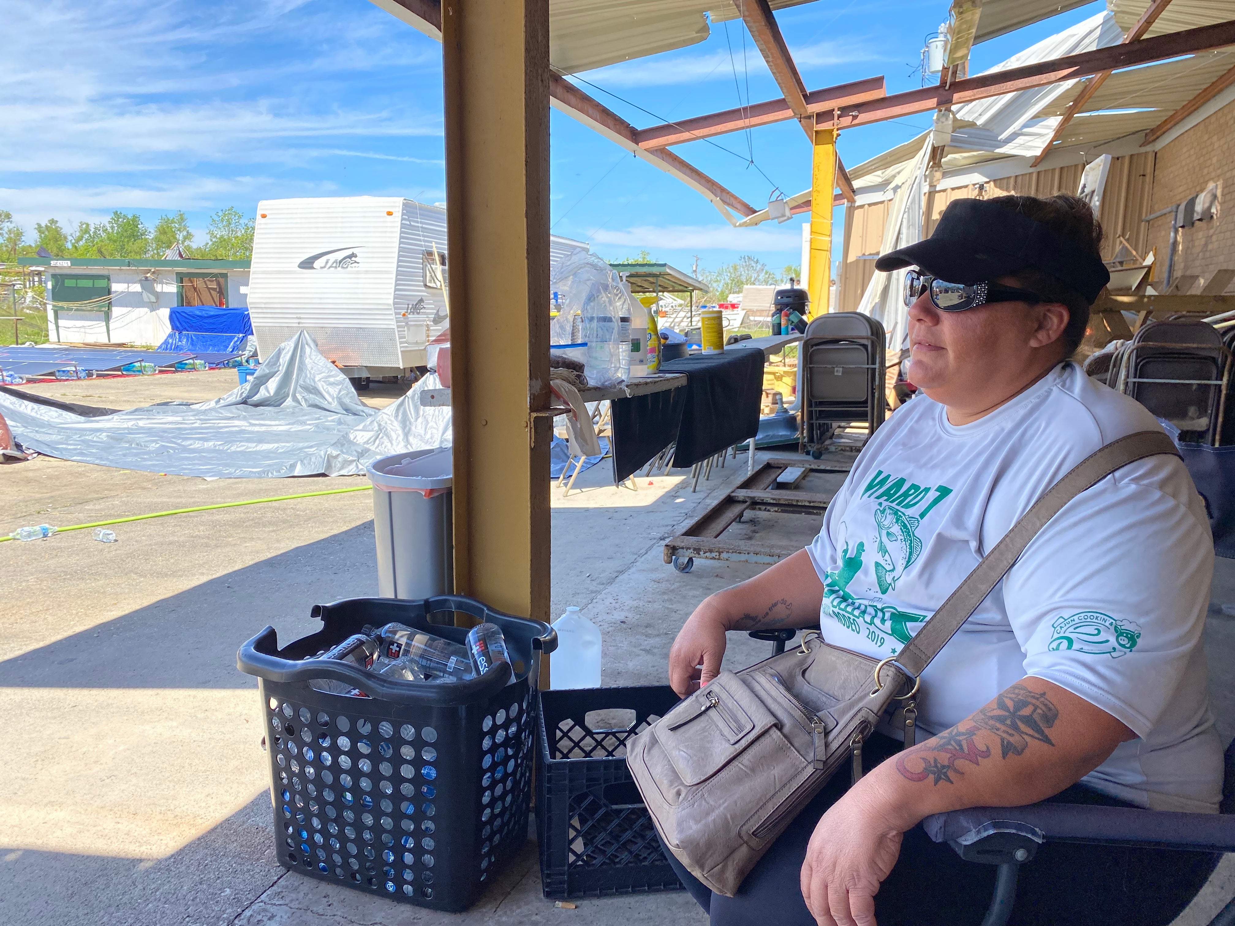 Keisha Foret sits in the parking lot of the Ward 7 Citizens Club in Chauvin, Louisiana. She lives in a camper there after her home was destroyed in Hurricane Ida.