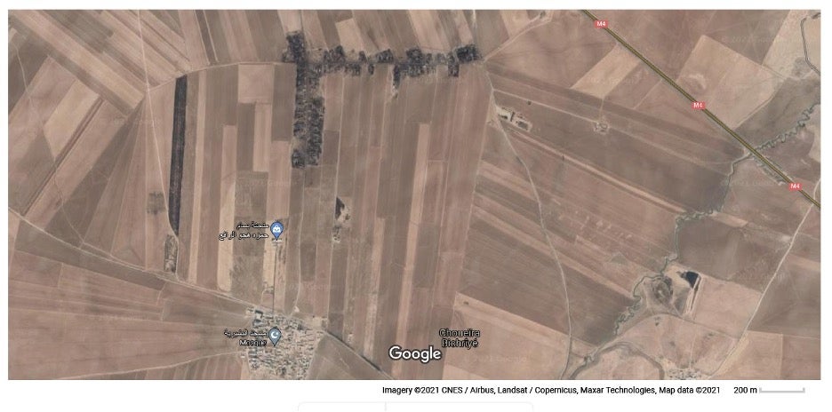 The satellite image of Beshayriya village in 2021 shows how the land around the village has been affected by the makeshift refineries