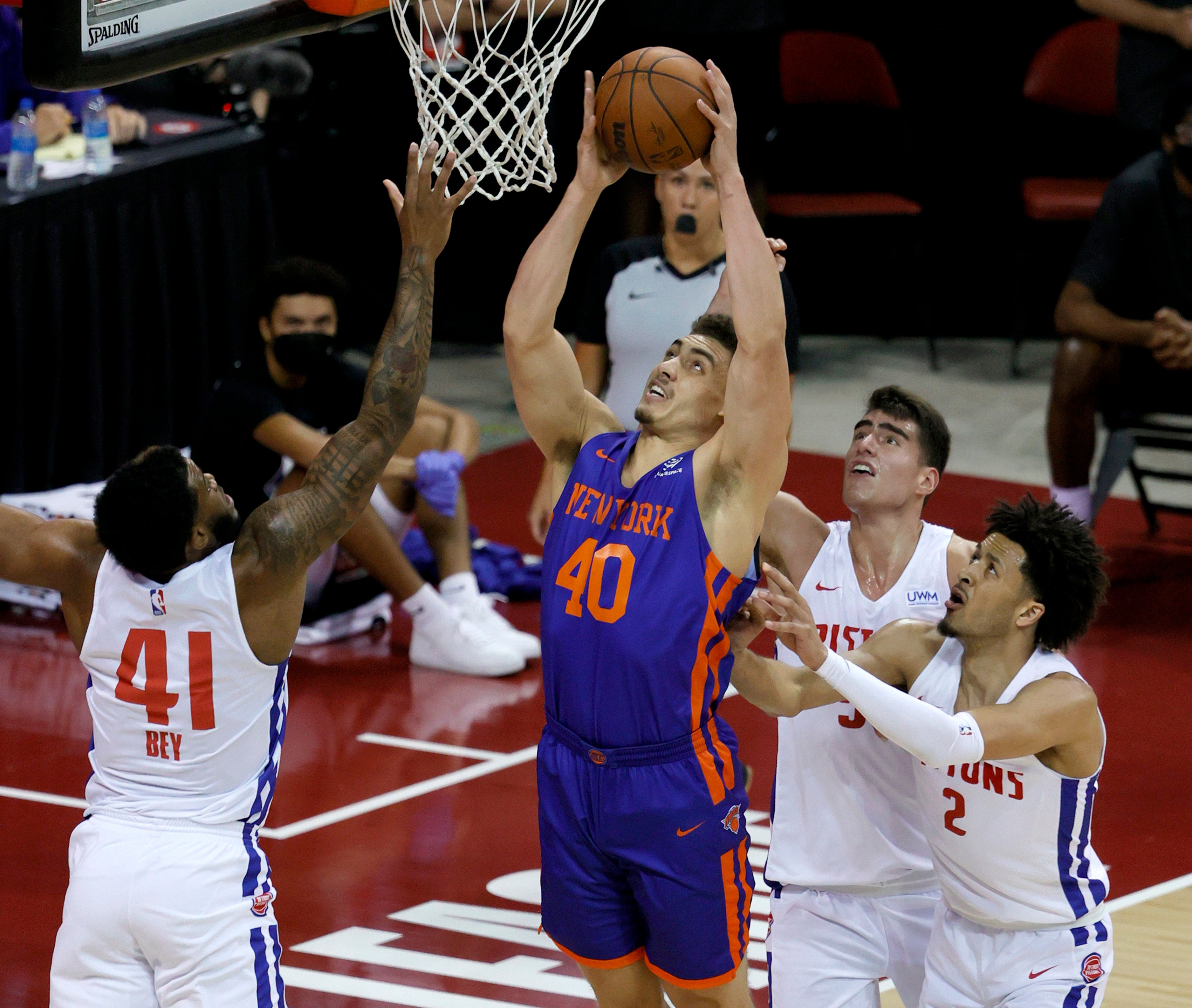 Reid Travis of the New York Knicks shoots against Saddiq Bey, Luka Garzaz and Cade Cunningham of the Detroit Pistons during the 2021 NBA Summer League at the Thomas & Mack Center on 13 August 2021 in Las Vegas, Nevada