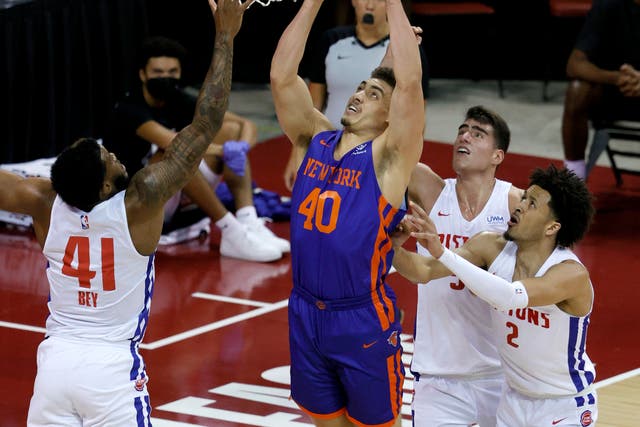 <p>Reid Travis of the New York Knicks shoots against Saddiq Bey, Luka Garzaz and Cade Cunningham of the Detroit Pistons during the 2021 NBA Summer League at the Thomas & Mack Center on 13 August 2021 in Las Vegas, Nevada</p>