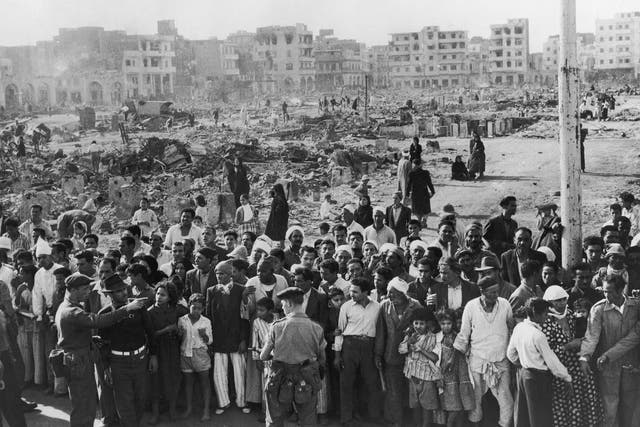<p>12 November 1956: British soldiers supervise a crowd in Port Said while food is distributed during the Suez Crisis</p>