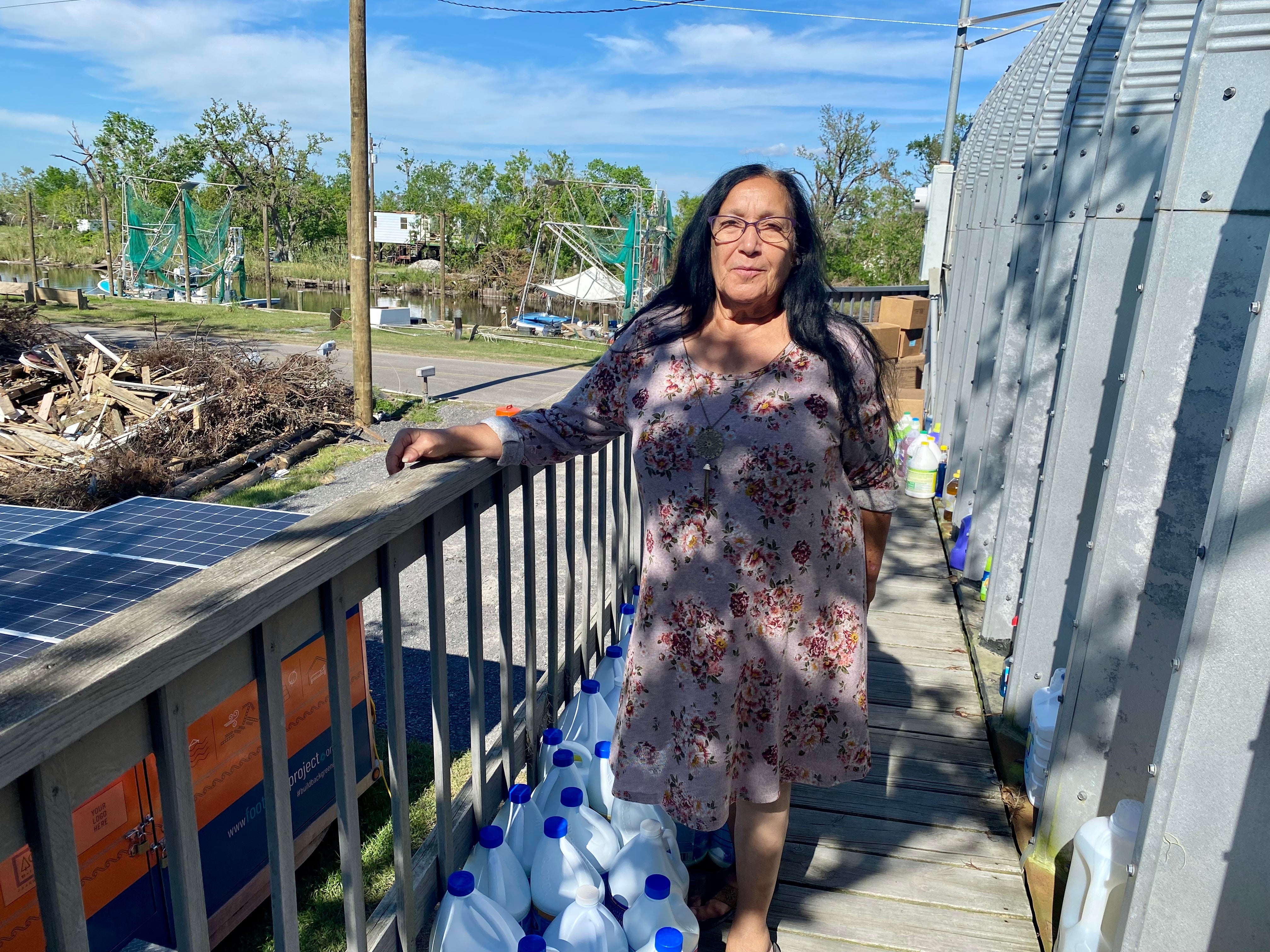 Theresa Dardar, a member of the Pointe-Au-Chien Indian Tribe, stands outside the tribal community center in Hurricane Ida’s aftermath.