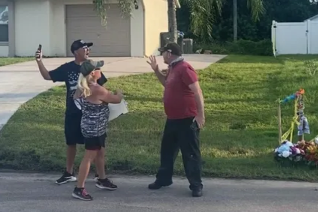 <p>A Laundrie neighbour confronts a protester on Wednesday evening</p>