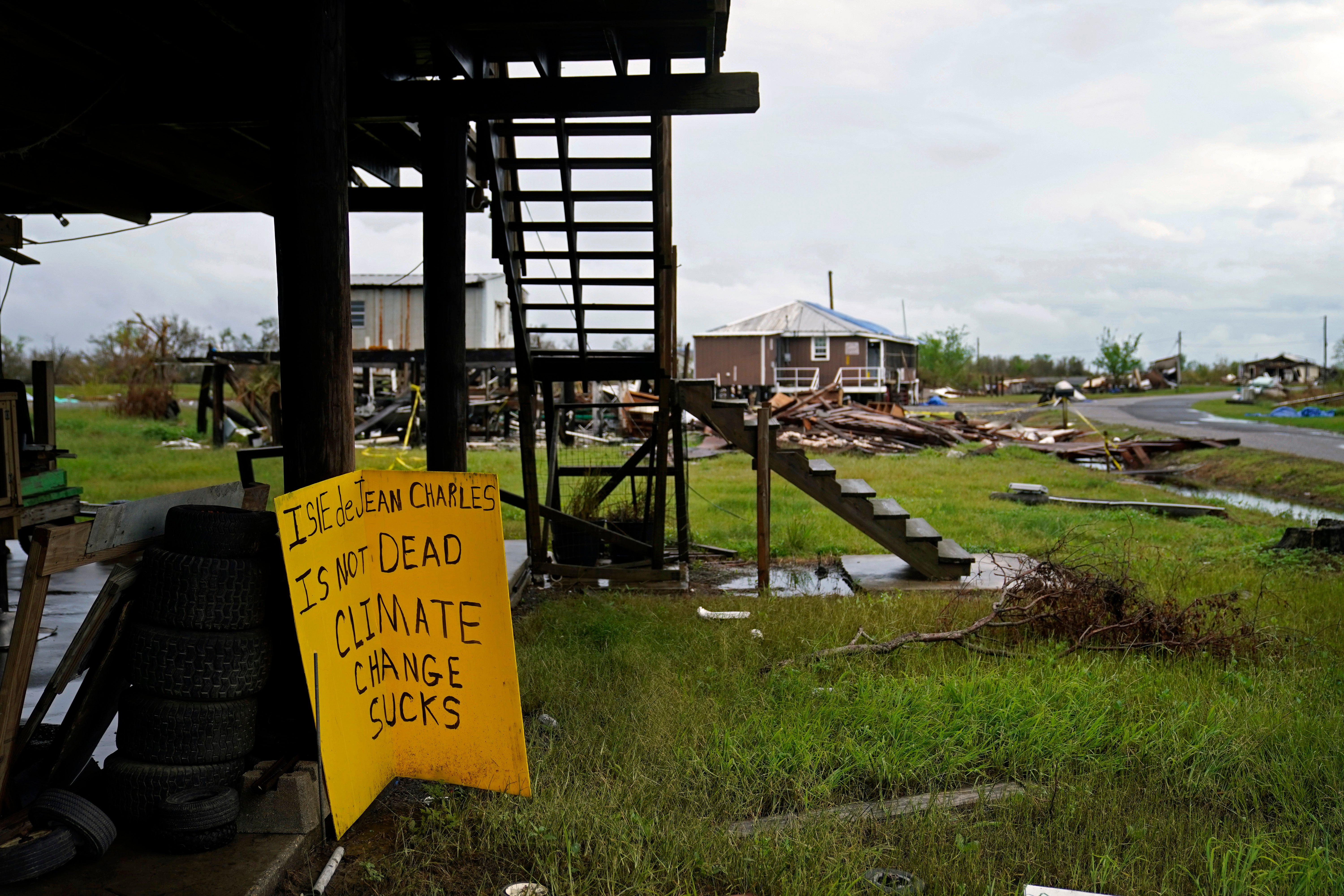 Chris Brunet posted a sign in Isle de Jean Charles, an eroding island on the Louisiana coast, in Hurricane Ida’s aftermath.