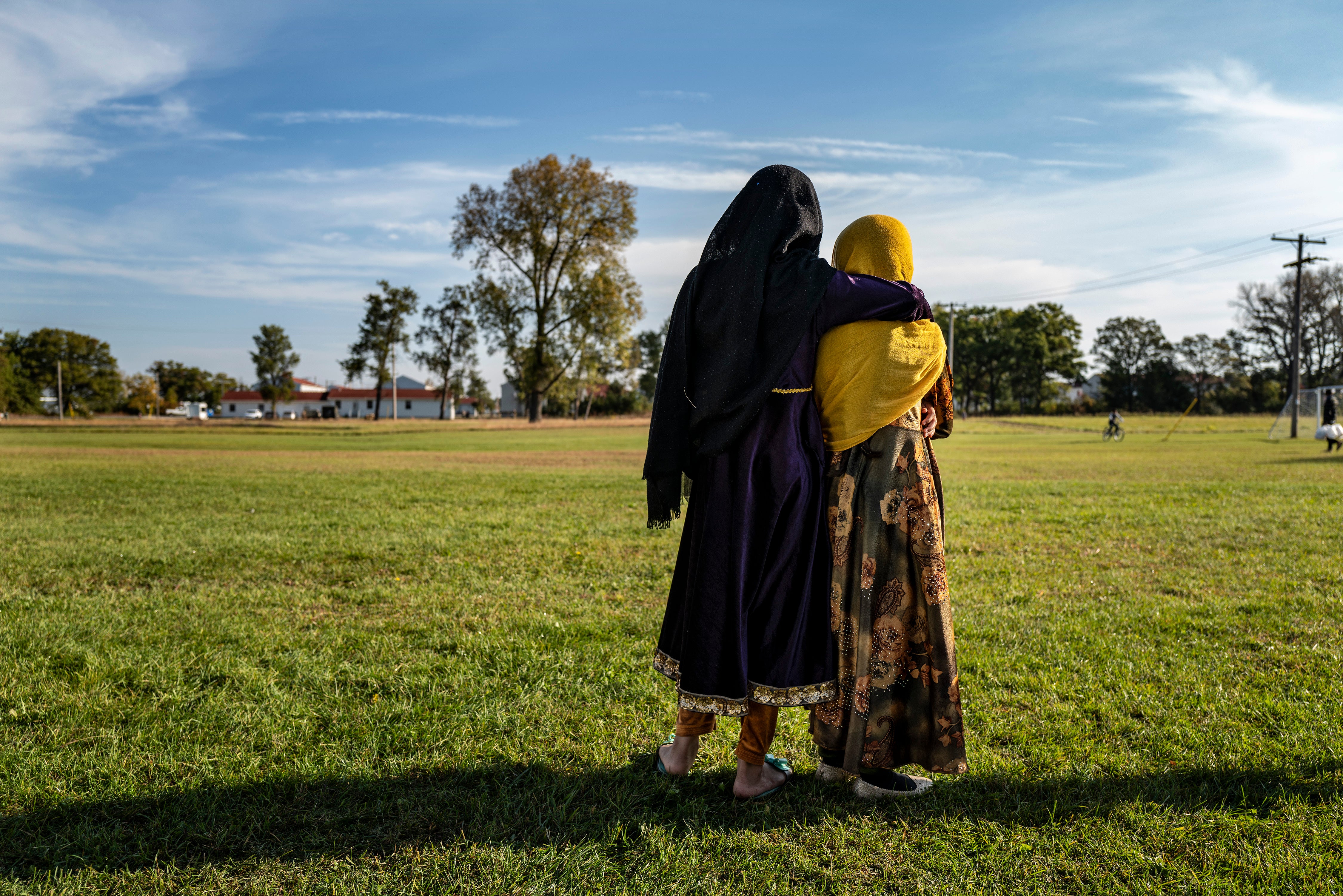 Afghan refugee girls watch football game at an army base in Wisconsin