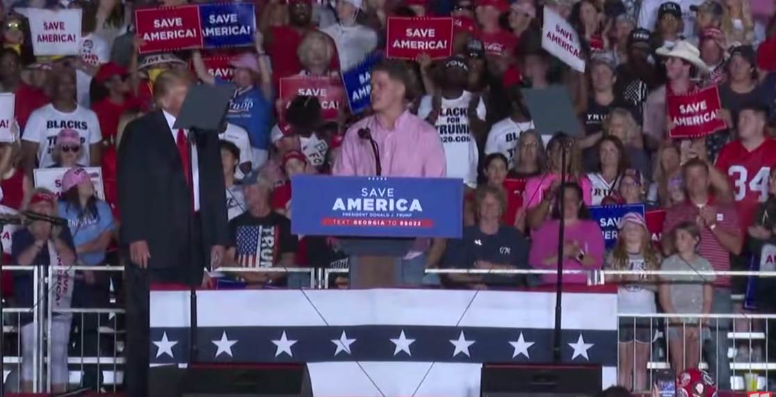Lance Cpl Hunter Clark onstage with Donald Trump in Georgia.