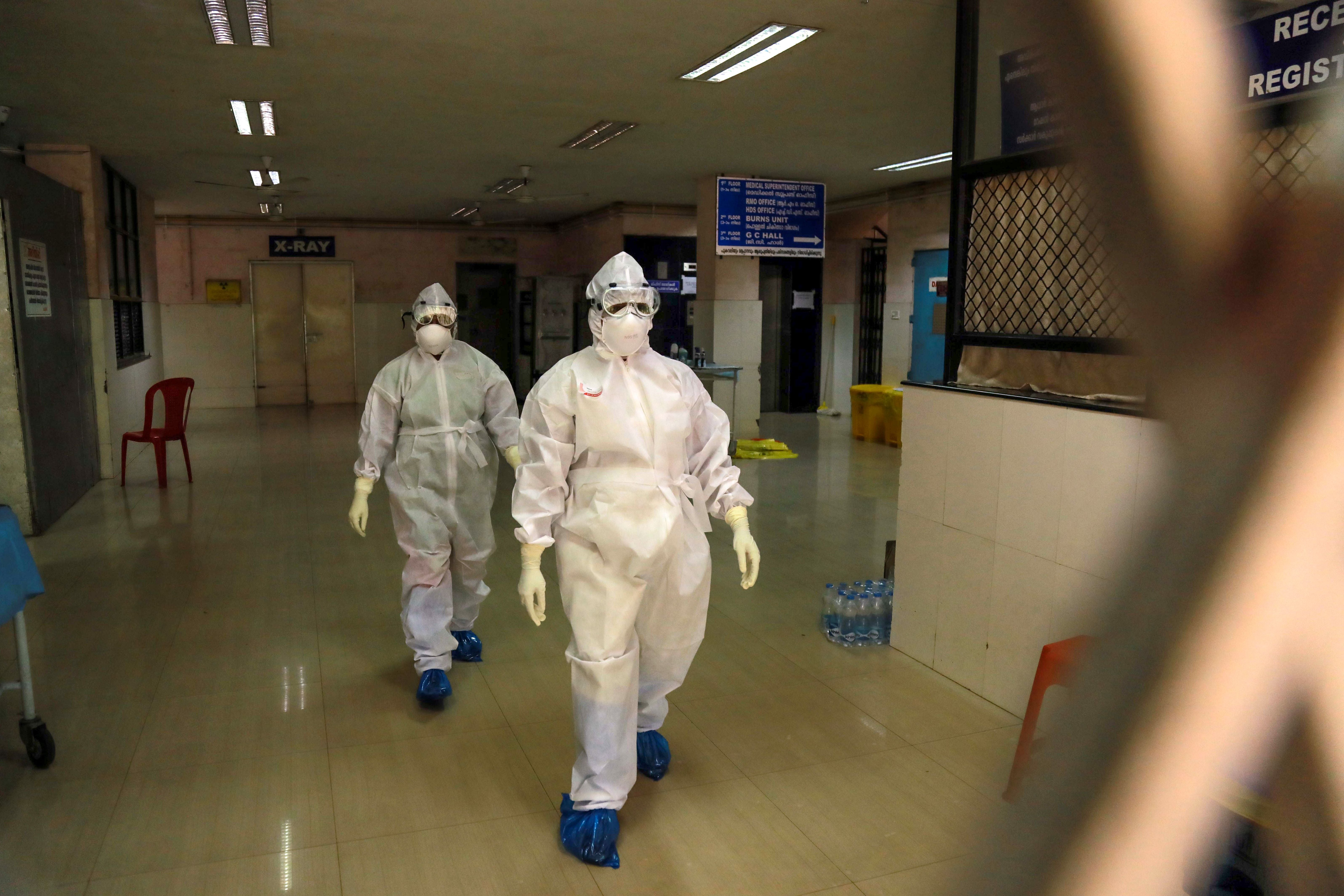 File. Health officials in full protective gear walk inside an isolation ward in October 2021 in the Indian state of Kerala after 23-year-old was infected by the potentially deadly Nipah virus