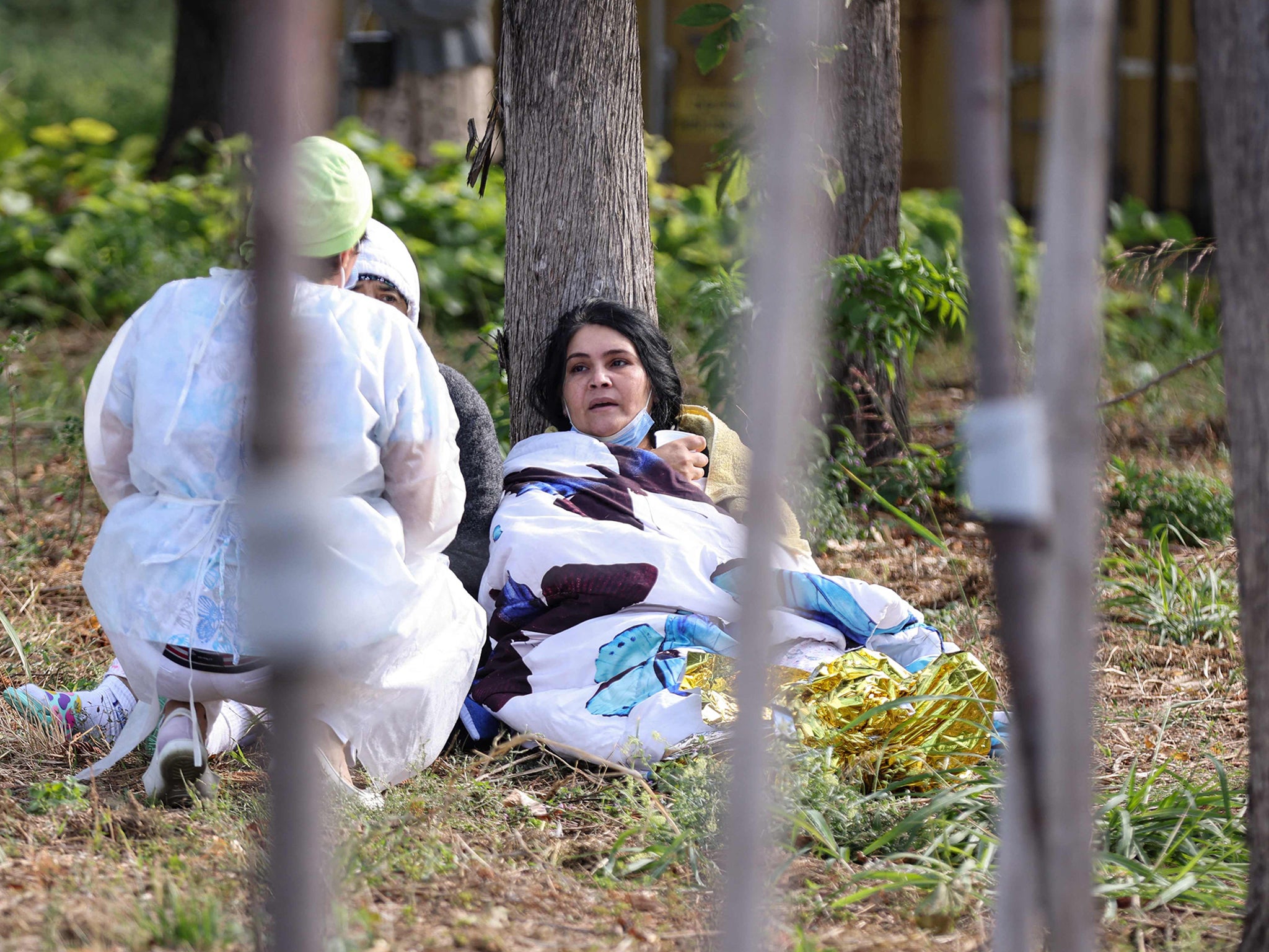 A hospital worker checks on evacuated patients