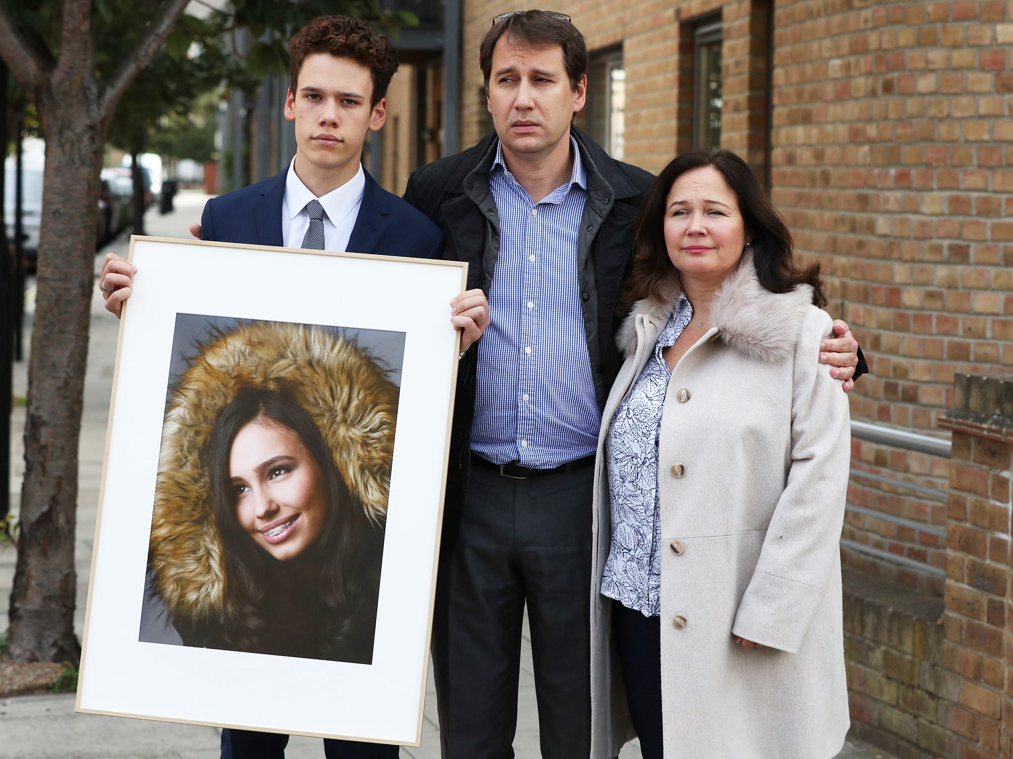 Nadim and Tanya Ednan-Laperouse, with their son Alex holding a portrait of Natasha, in 2018