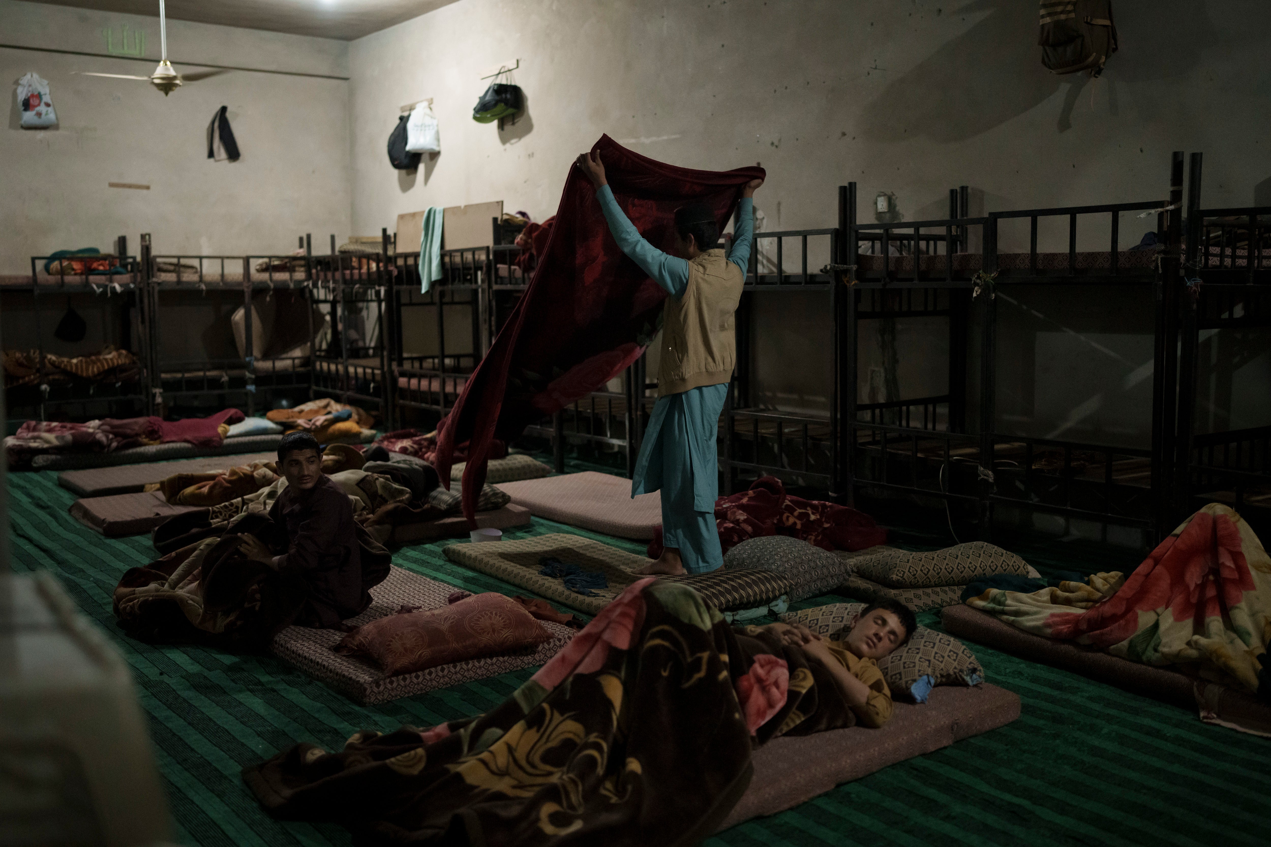 Afghan students wake up before the morning prayer at the Khatamul Anbiya madrasa in Kabul, Afghanistan