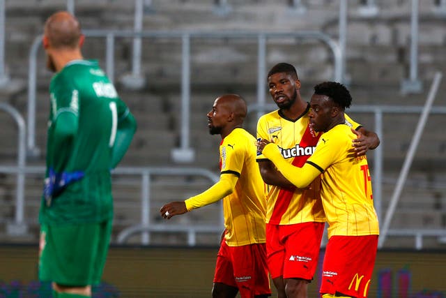 Arnaud Kalimuendo, right, celebrates after scoring Lens’ second goal against Reims (Michel Spingler/AP)
