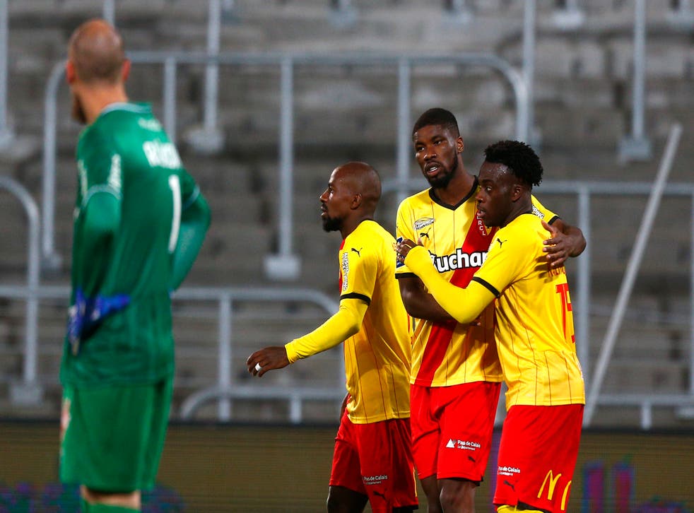 Arnaud Kalimuendo, right, celebrates after scoring Lens’ second goal against Reims (Michel Spingler/AP)