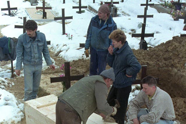 <p>A Serbian seals the casket containing the remains of a newly exhumed body from a Serb-held cemetery in Ilidja, near Sarajevo, 1996</p>