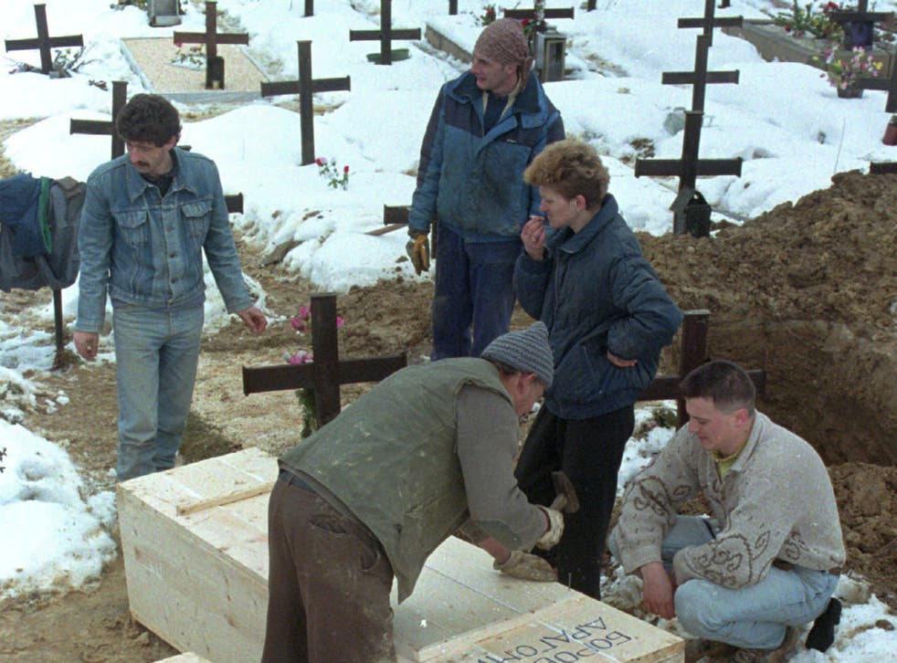<p>A Serbian seals the casket containing the remains of a newly exhumed body from a Serb-held cemetery in Ilidja, near Sarajevo, 1996</p>