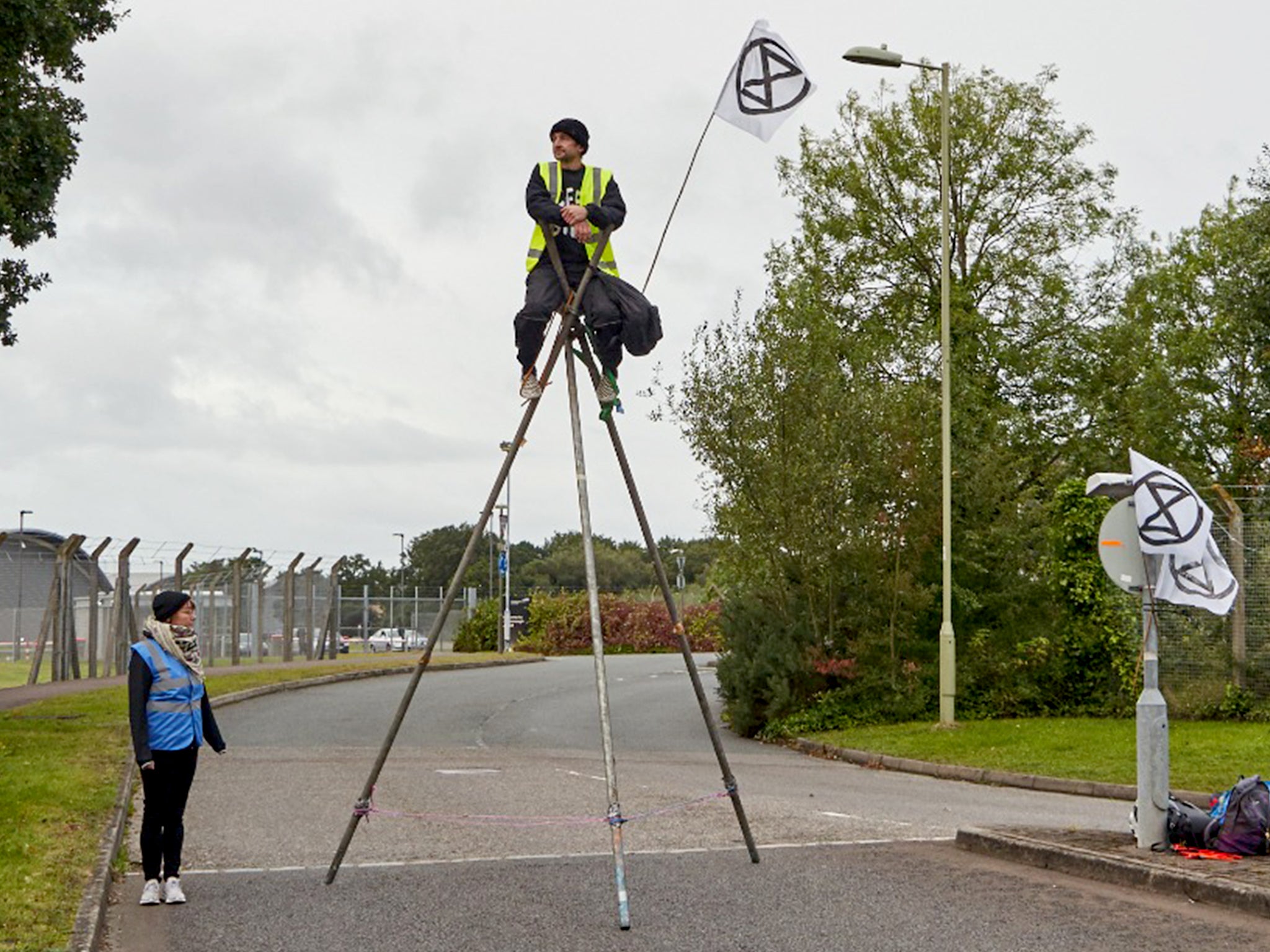 <p>Extinction Rebellion activists block one of the entrances to Farnborough airport in Hampshire</p>