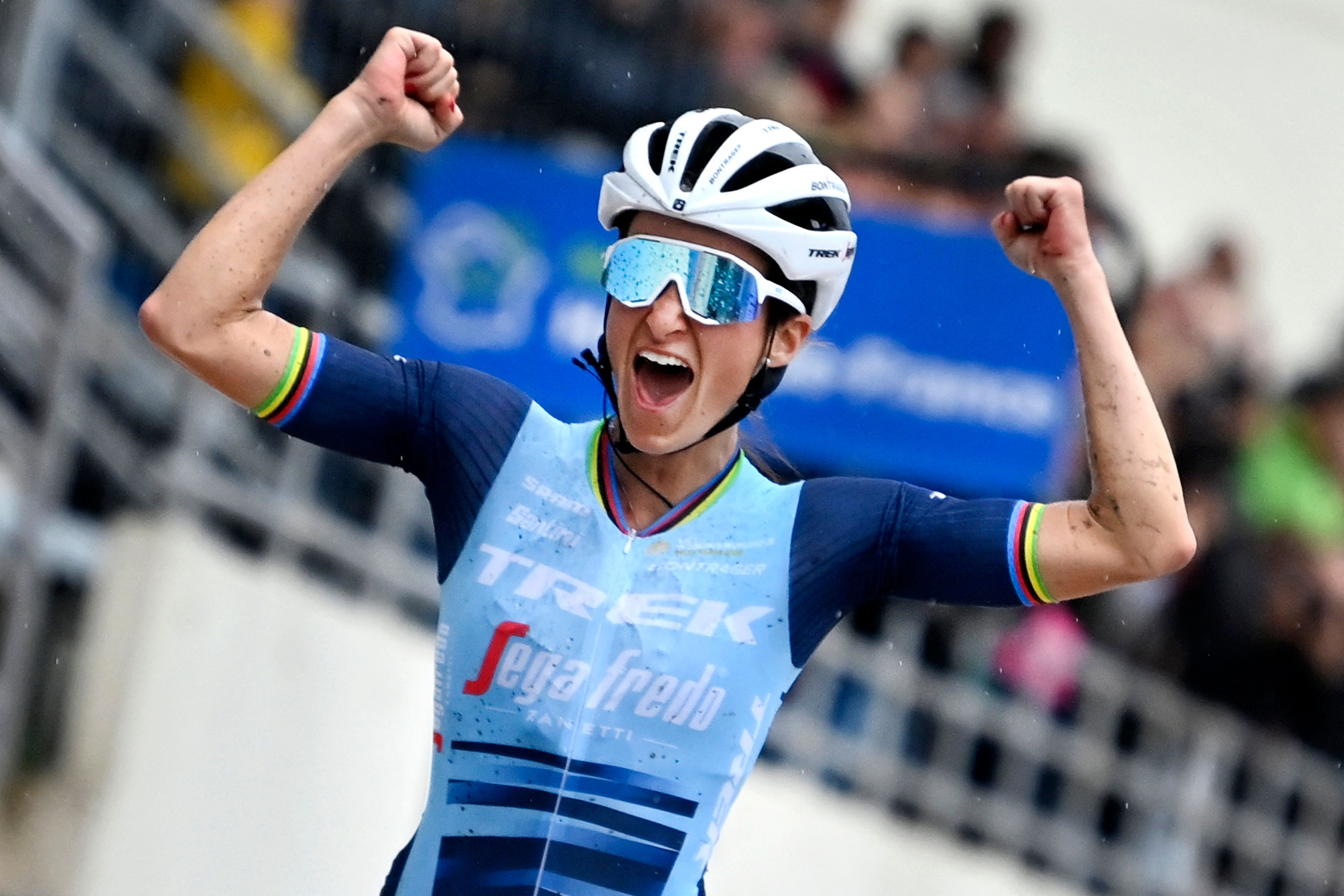 Lizzie Deignan celebrates as she crosses the finish line to win the first edition of the women elite race of the 'Paris-Roubaix' cycling event