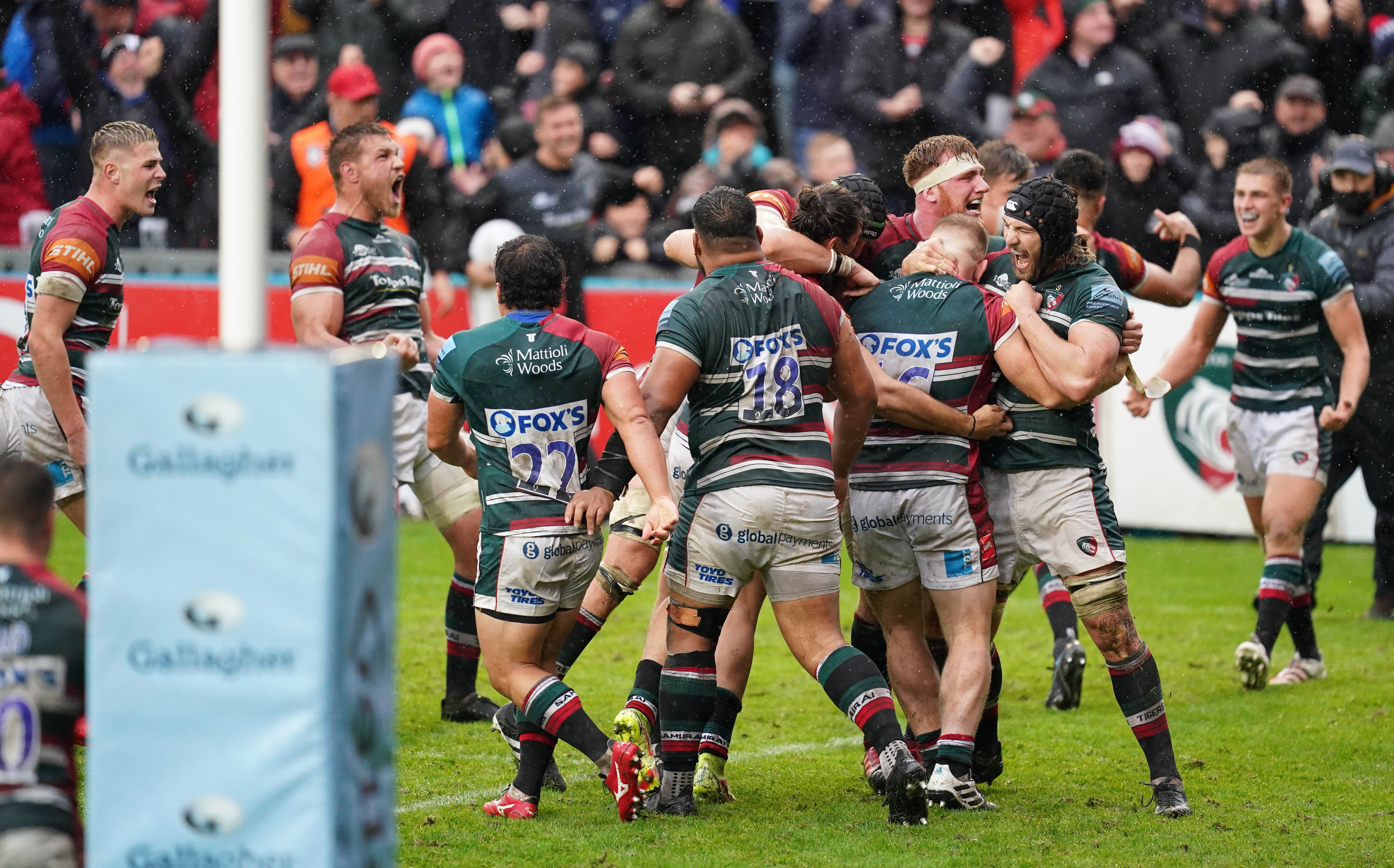 Leicester Tigers players celebrate after being awarded a penalty try to win the game (David Davies/PA)