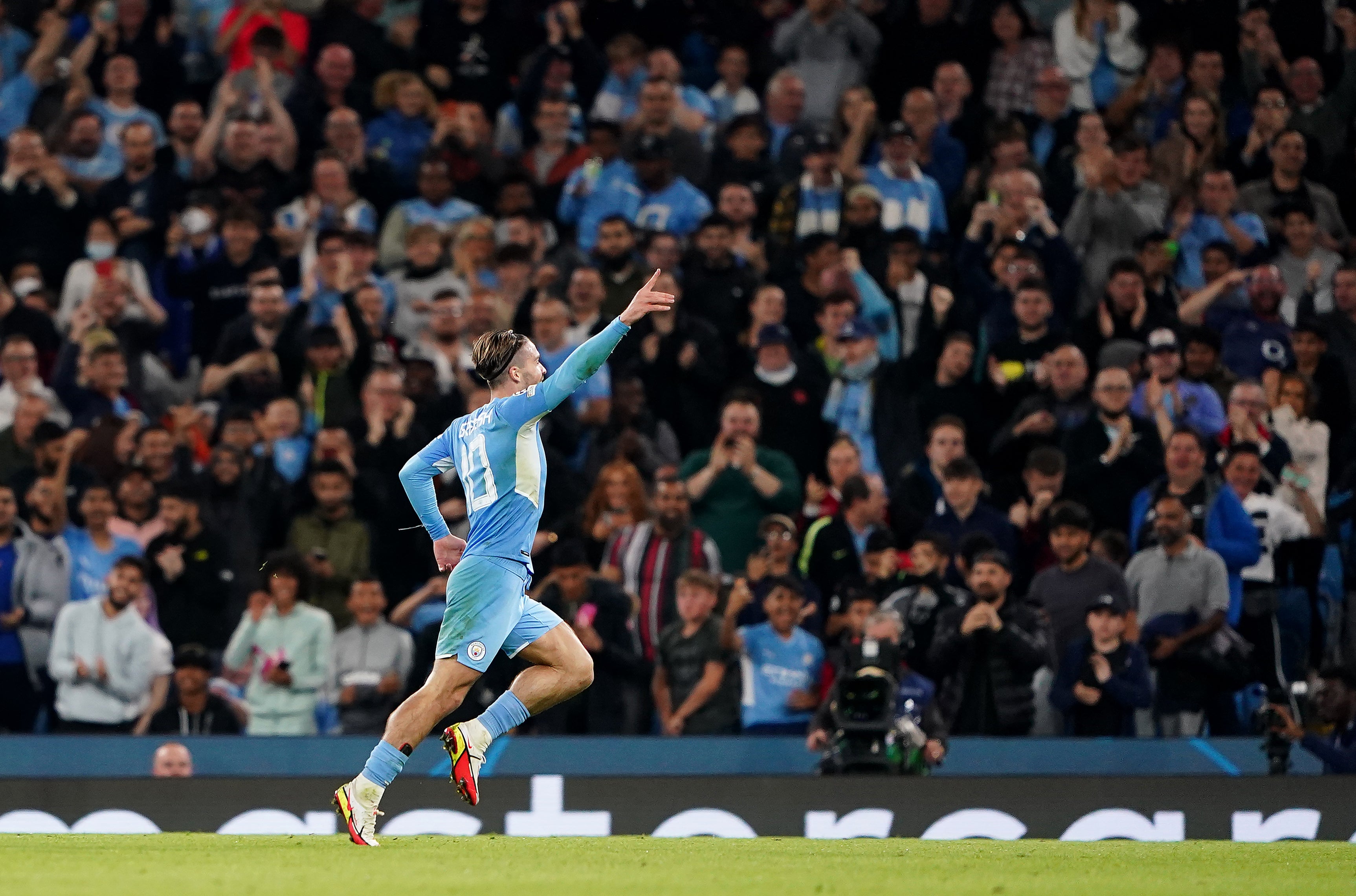 Jack Grealish celebrates scoring in the Champions League for Manchester City (Zac Goodwin/PA).