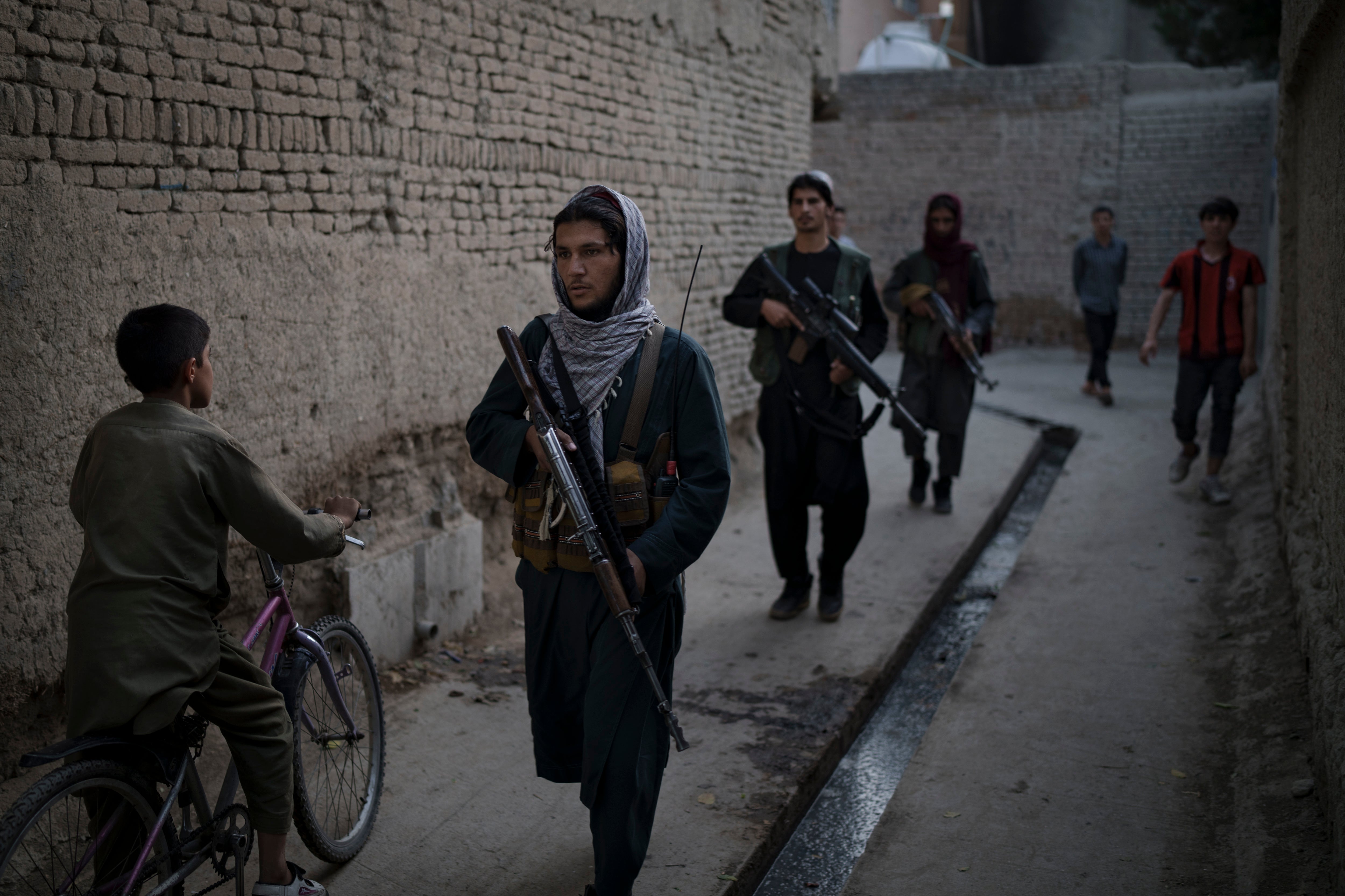 Armed Taliban fighters patrol a neighbourhood in Kabul