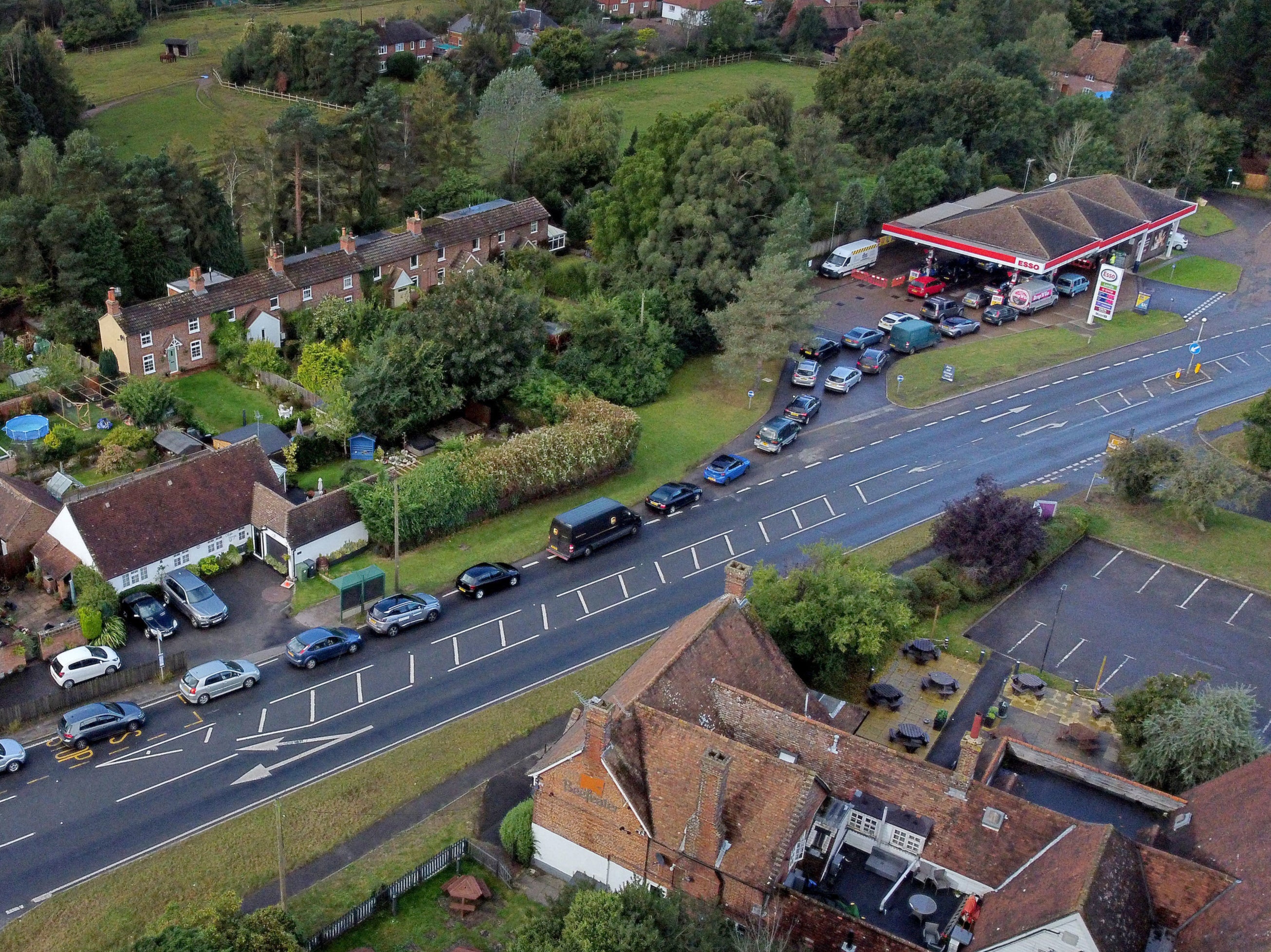 Motorists queue for fuel at an Esso petrol station in Ashford, Kent