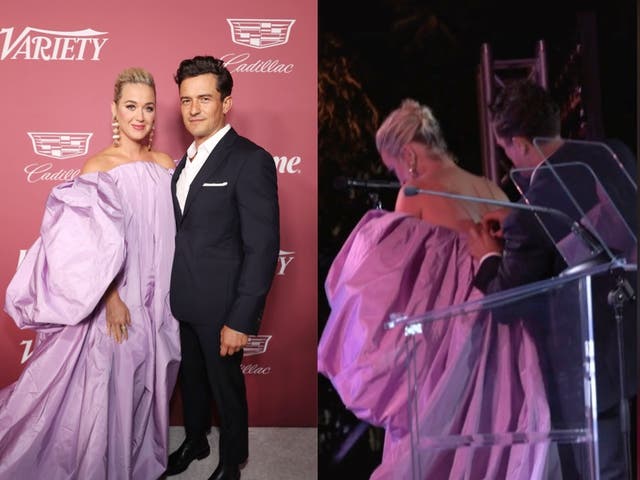 <p>Orlando Bloom helps Katy Perry on stage with her dress</p>