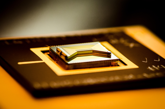 A chip containing an ion trap that researchers use to capture and control atomic ion qubits (quantum bits).