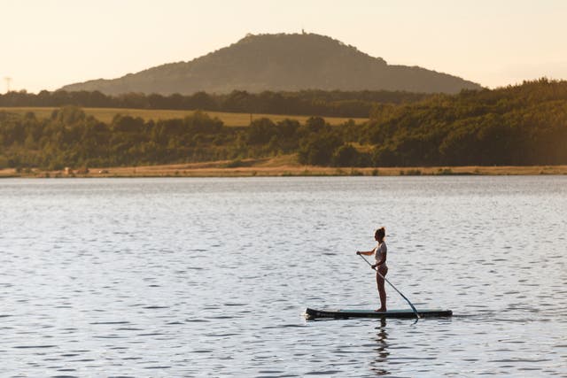 <p>A paddle boarder on the tranquil, man-made Berzdorfer lake </p>