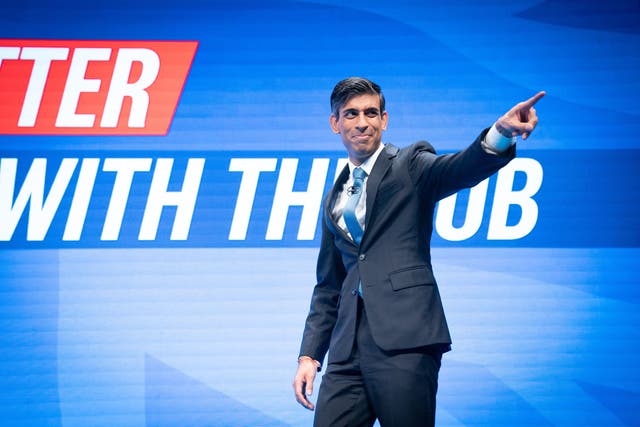 <p>Chancellor of the Exchequer, Rishi Sunak arrives on stage to deliver his keynote speech to the Conservative Party conference </p>