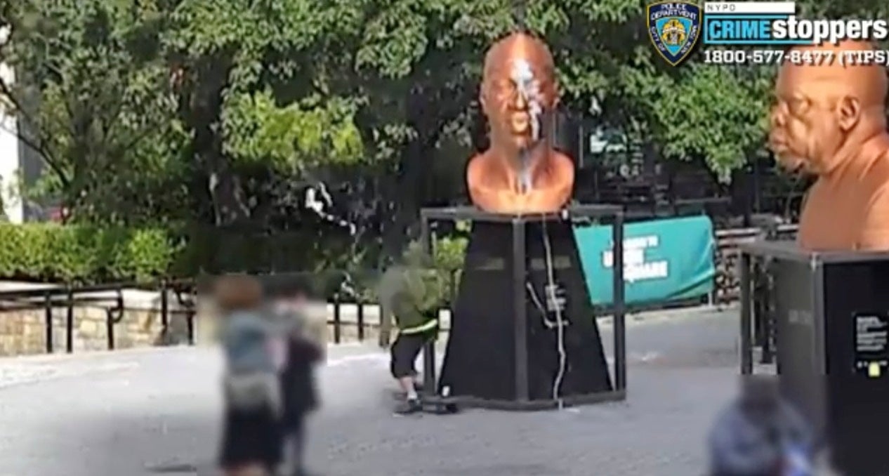 <p>A person vandalizes George Floyd's sculpture in New York, 3 October 2021, in this still image obtained from a social media video.</p>