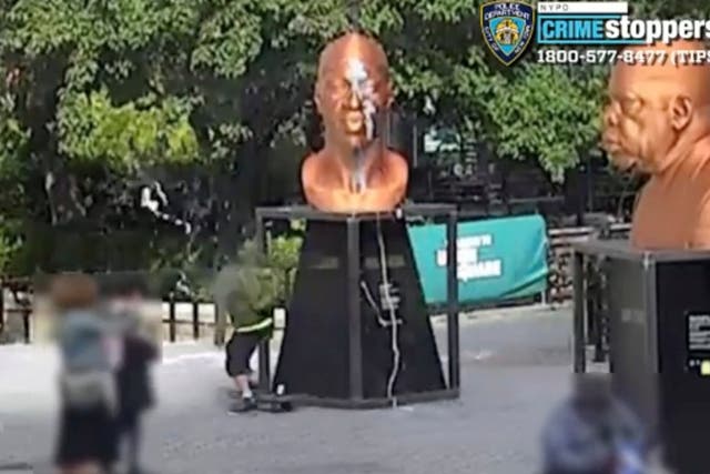<p>A person vandalizes George Floyd's sculpture in New York, 3 October 2021, in this still image obtained from a social media video.</p>