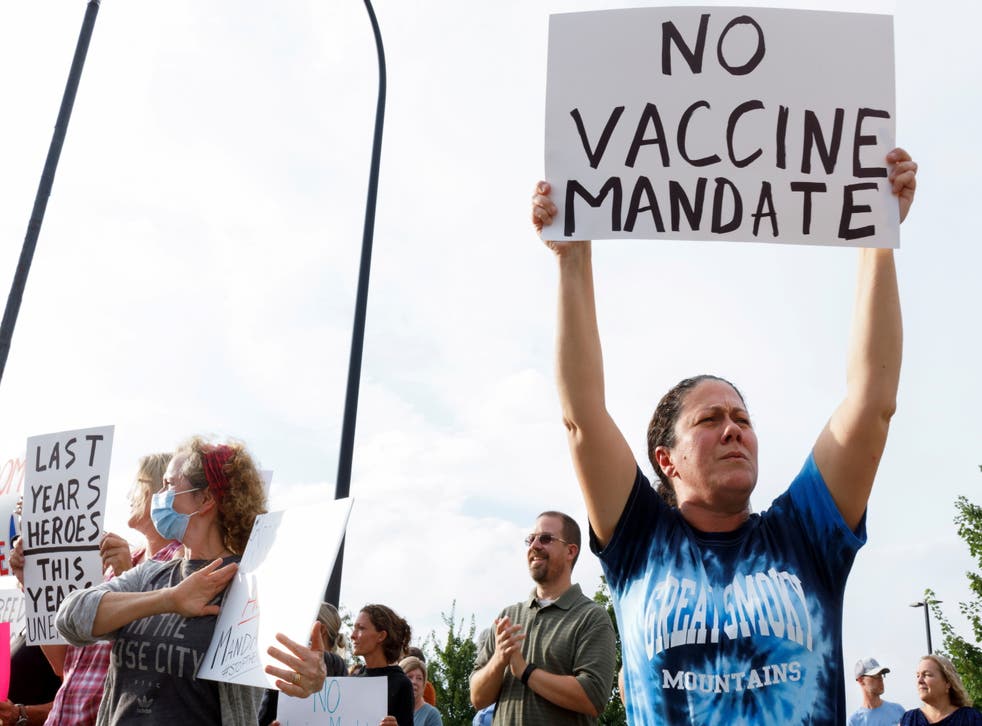 <p>Jamie Horning, 43, of Union Town, raises a sign to protest against the coronavirus vaccine mandates at Summa Health Hospital in Akron, Ohio, 16 August 2021</p>