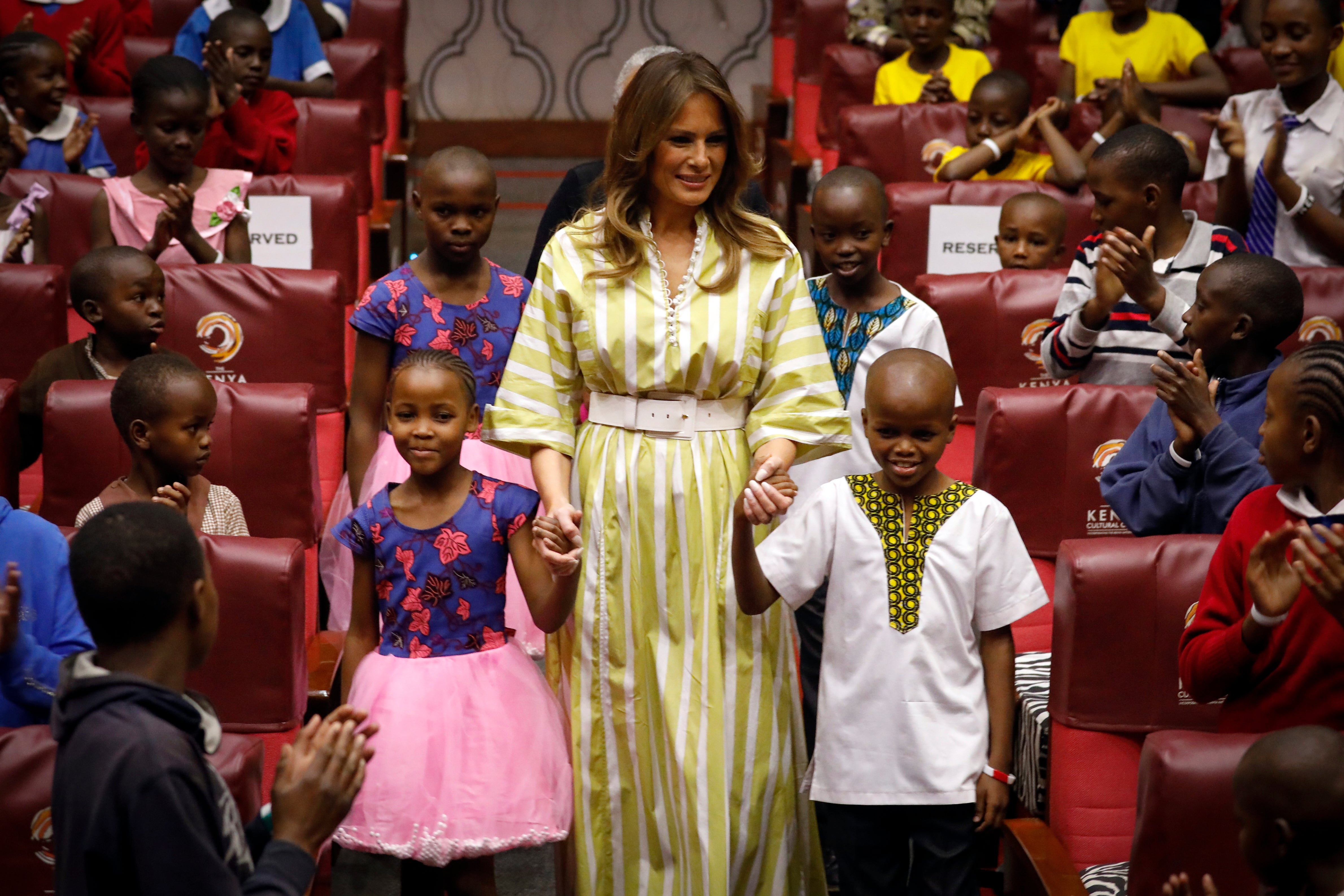 File: Former US first lady Melania Trump smiles as she holds hands with Kenyan children