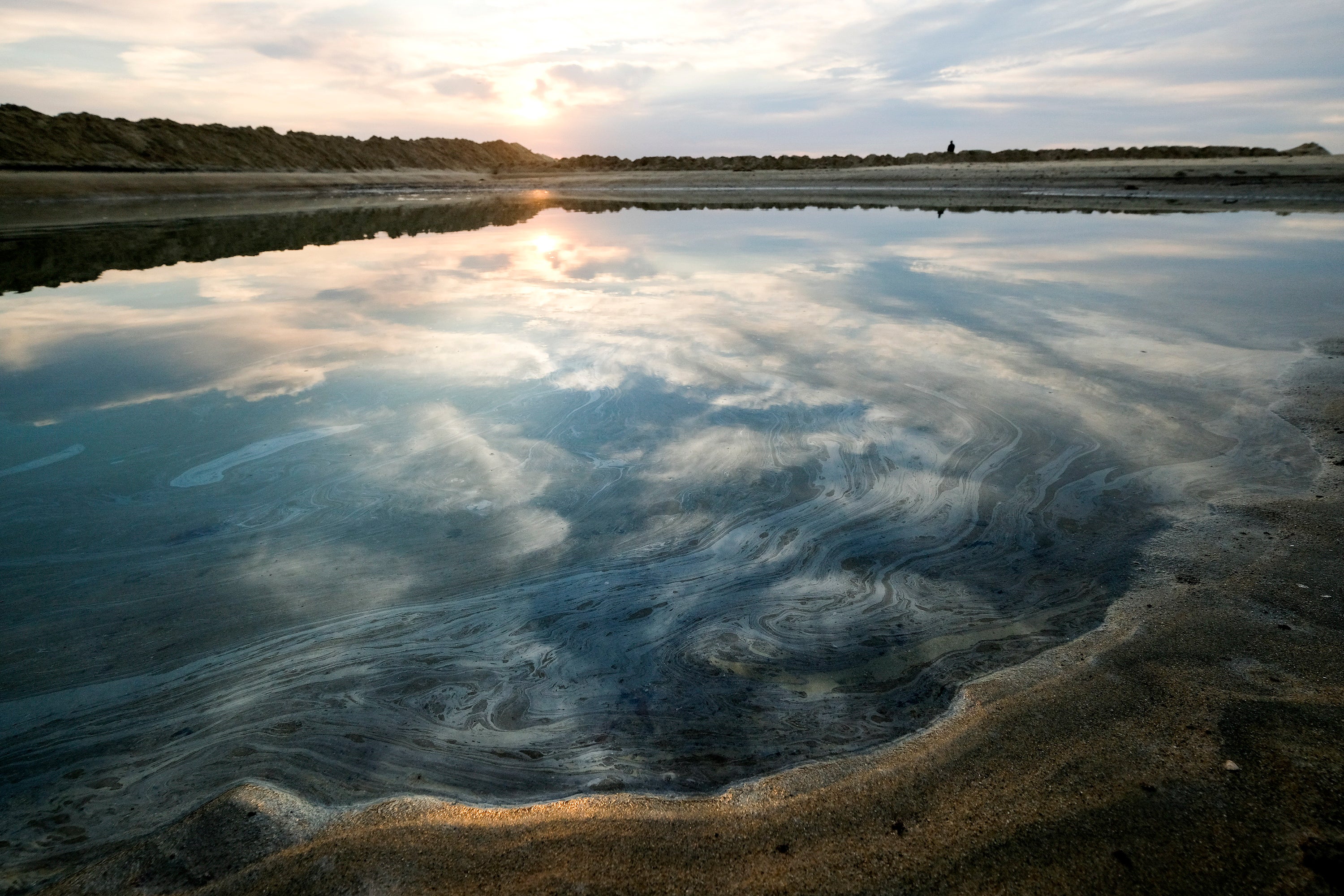 Oil floats on the water surface after an oil spill in Huntington Beach, Calif., on Monday, Oct. 4, 2021. A major oil spill off the coast of Southern California fouled popular beaches and killed wildlife while crews scrambled Sunday, to contain the crude before it spread further into protected wetlands.