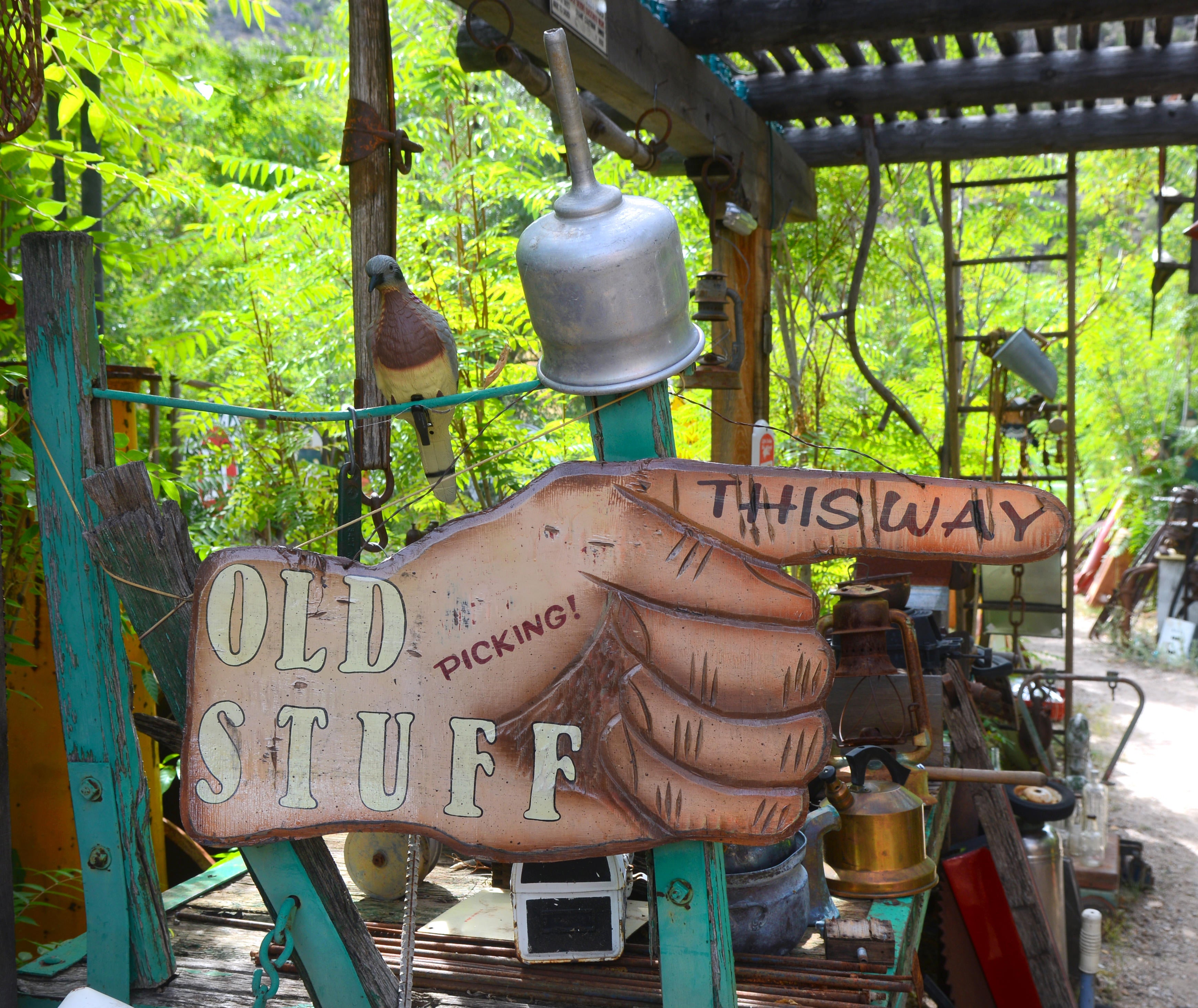 Hand sign pointing the way to antiques and secondhand items (Alamy/PA)