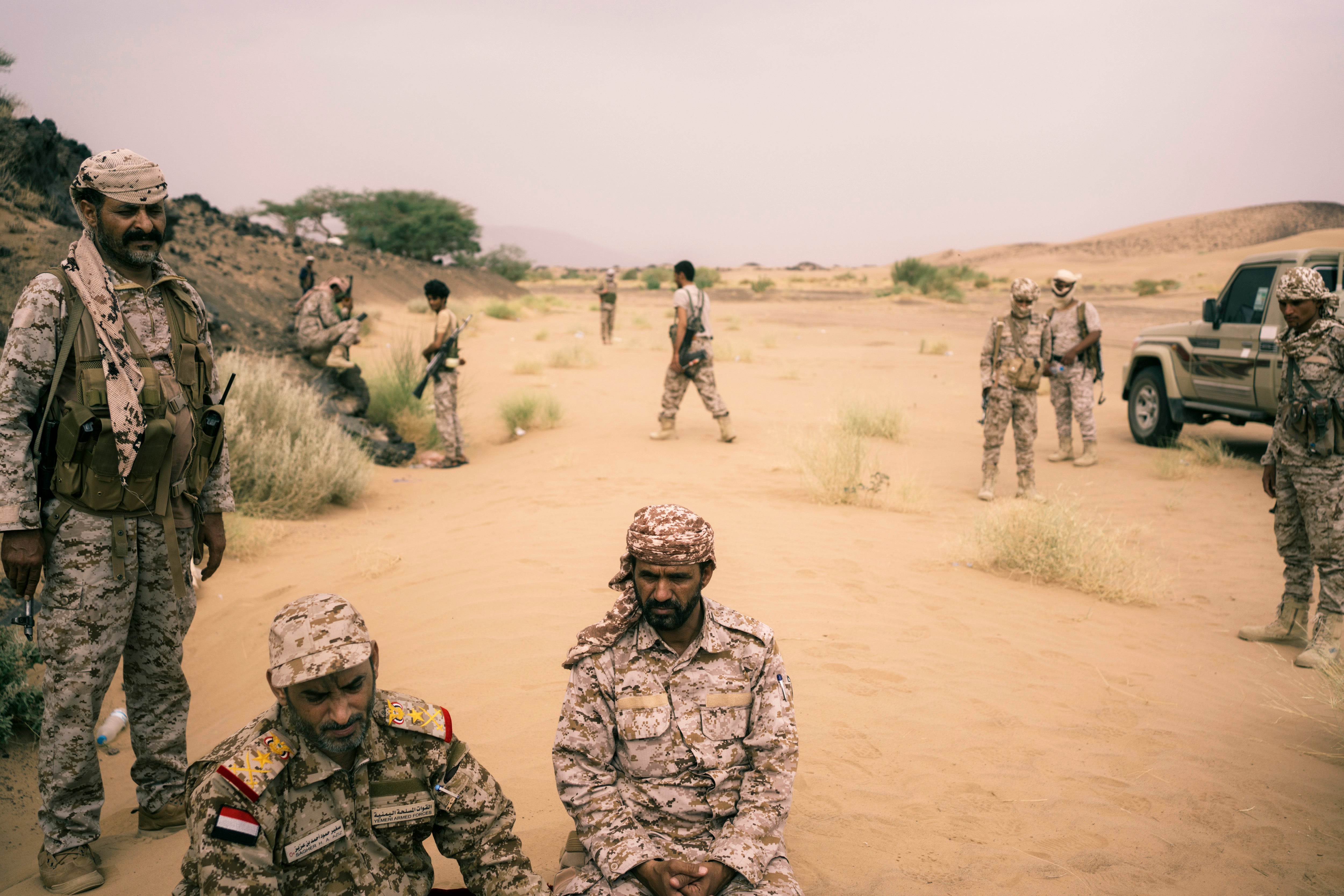 Yemeni army chief Lt Gen Sagheer bin Aziz, bottom left, sits near the front line outside Marib