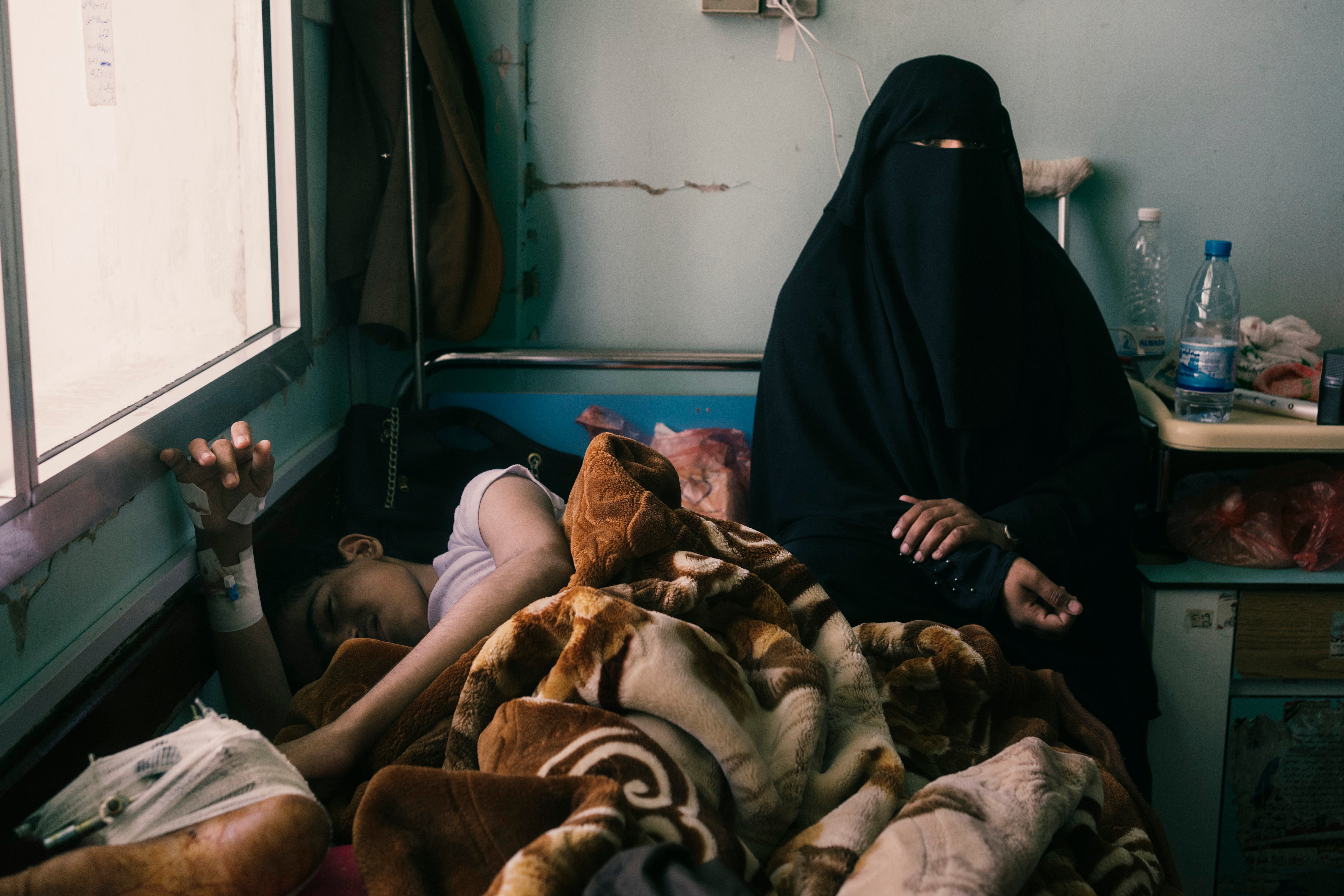 Badr al-Mufa, left, said to be 18, after being injured by a Houthi drone or missile